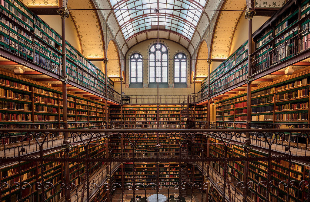 A four-story old library with thousands of books and a glass ceiling.