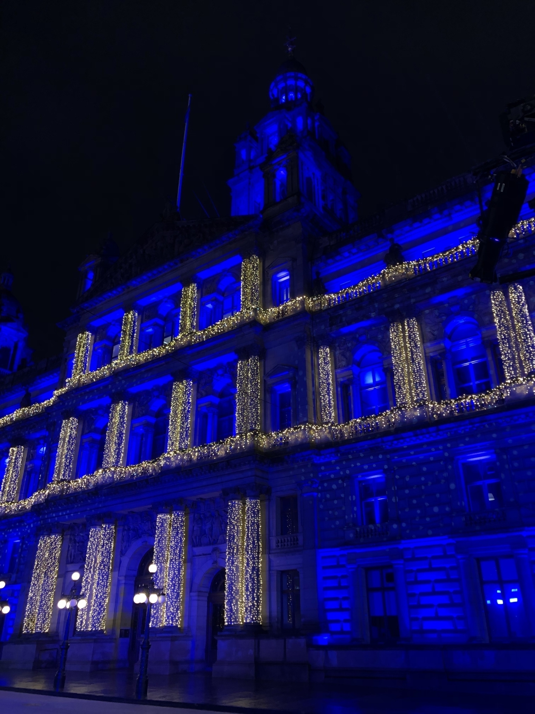 Grand building at night lit up with indigo lights
