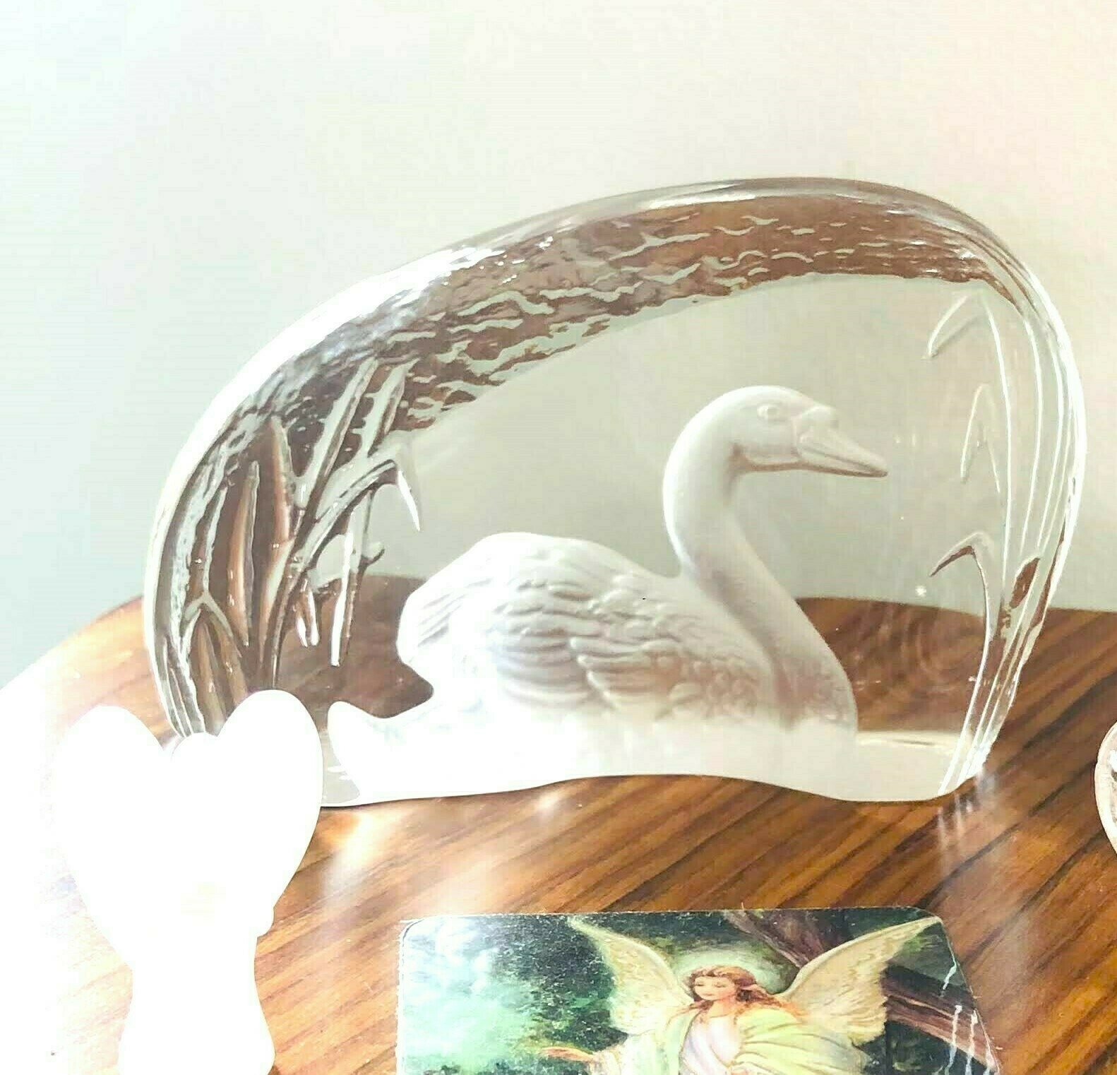 a swan etched into glass sitting on a table