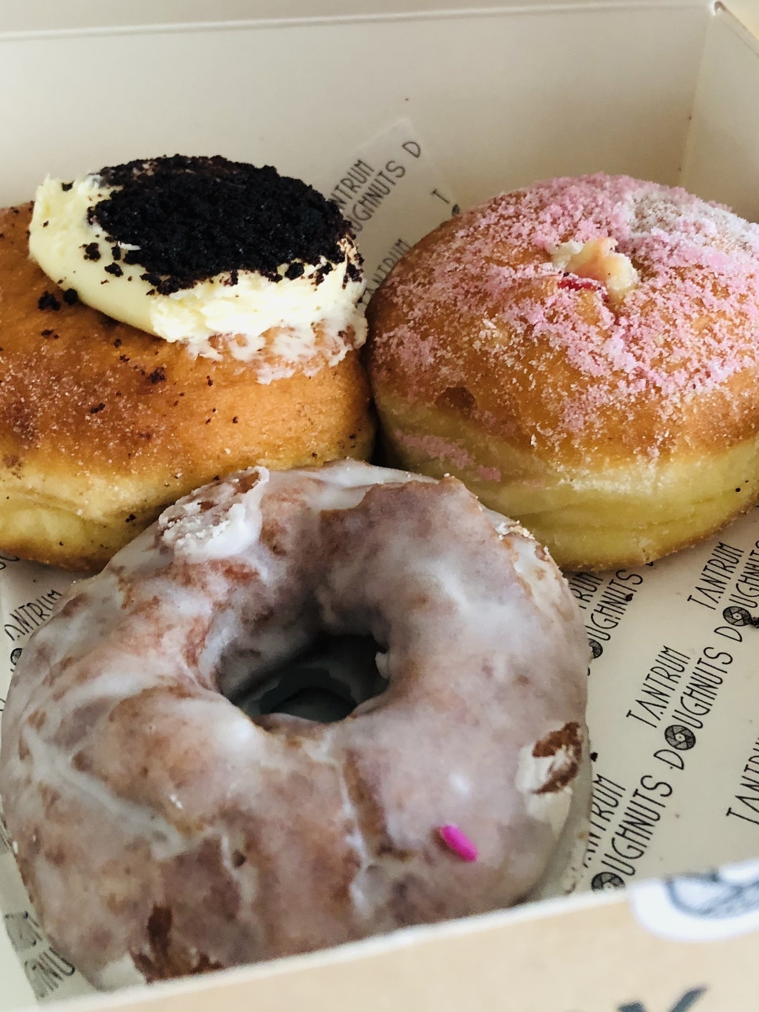 Three delicious donuts in a box