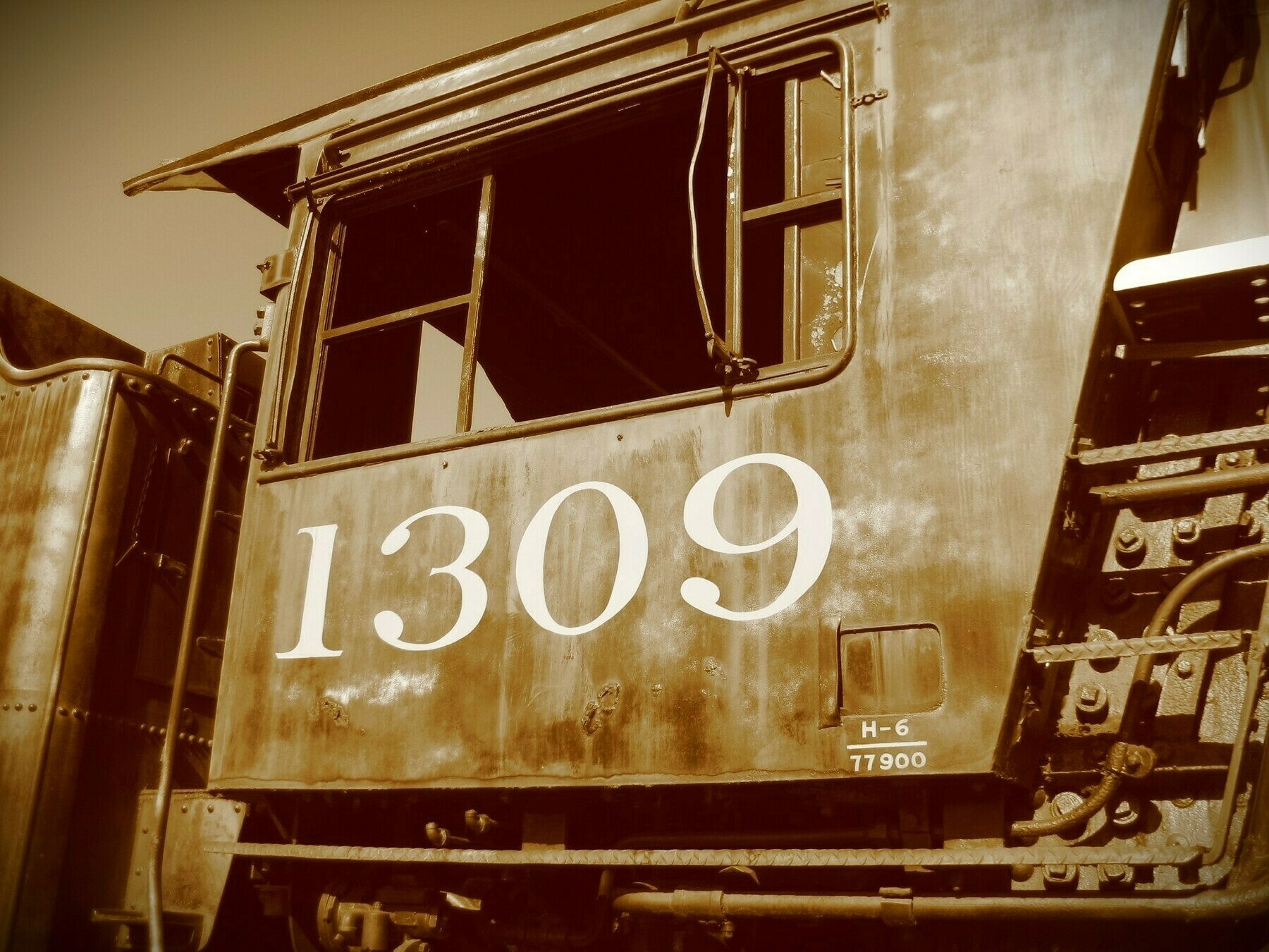 Sepia tone. Locomotive cab with the number 1309 painted on it.