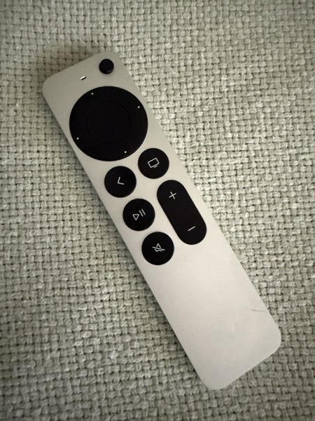 An AppleTV remote with a 3D printed replacement power button.