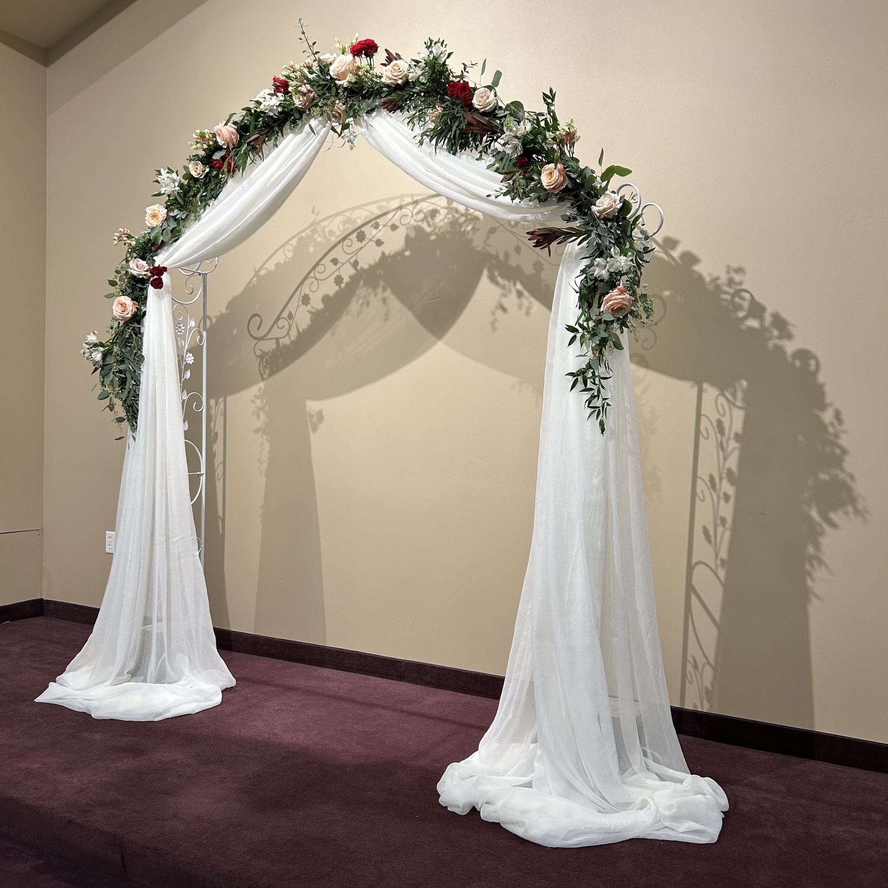 Flowers and fabric arch for a couple on their wedding day