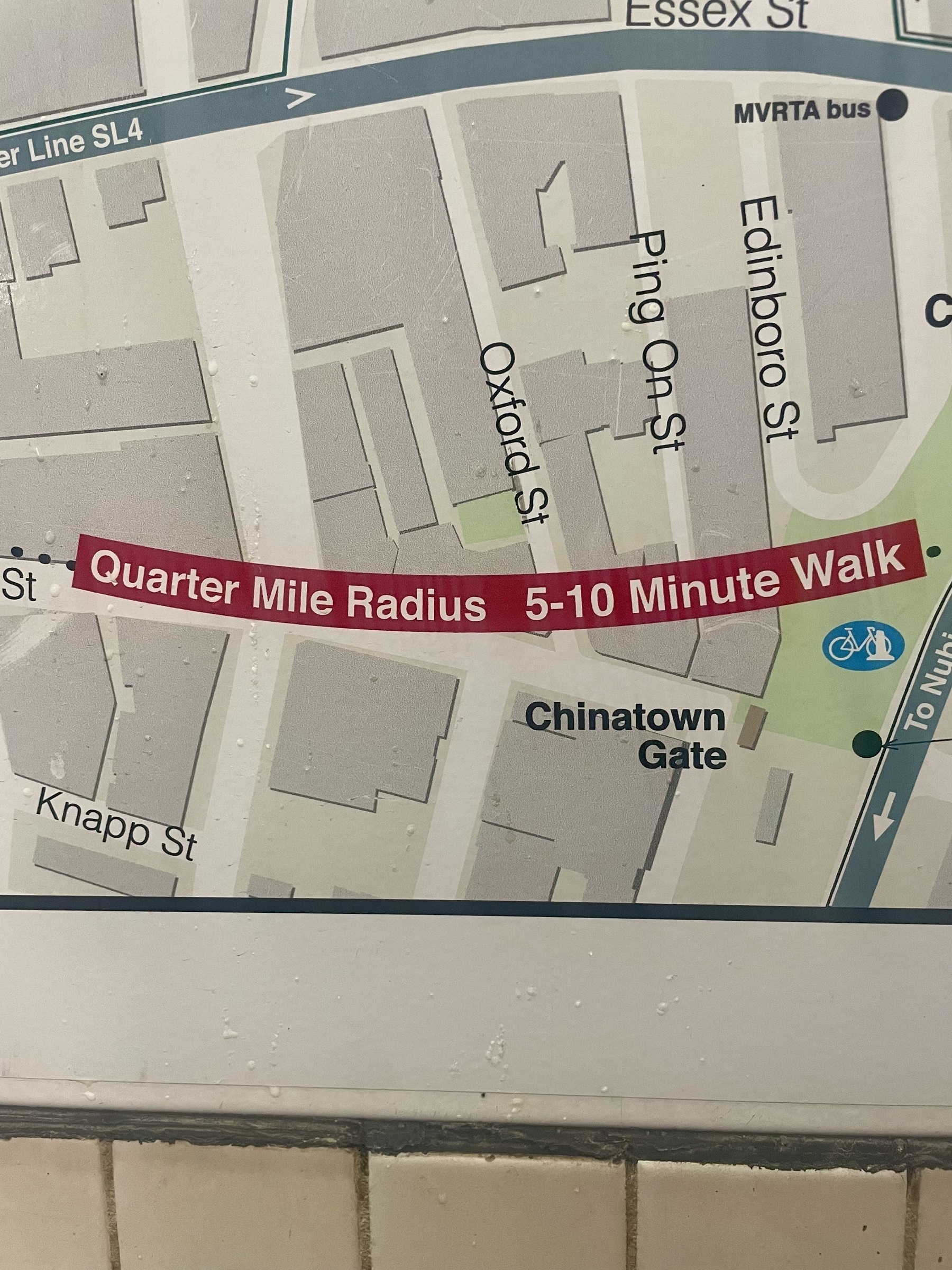 A close up of a map of downtown Boston has a dotted line circle that says: Quarter Mile Radius 5-10 min walk 