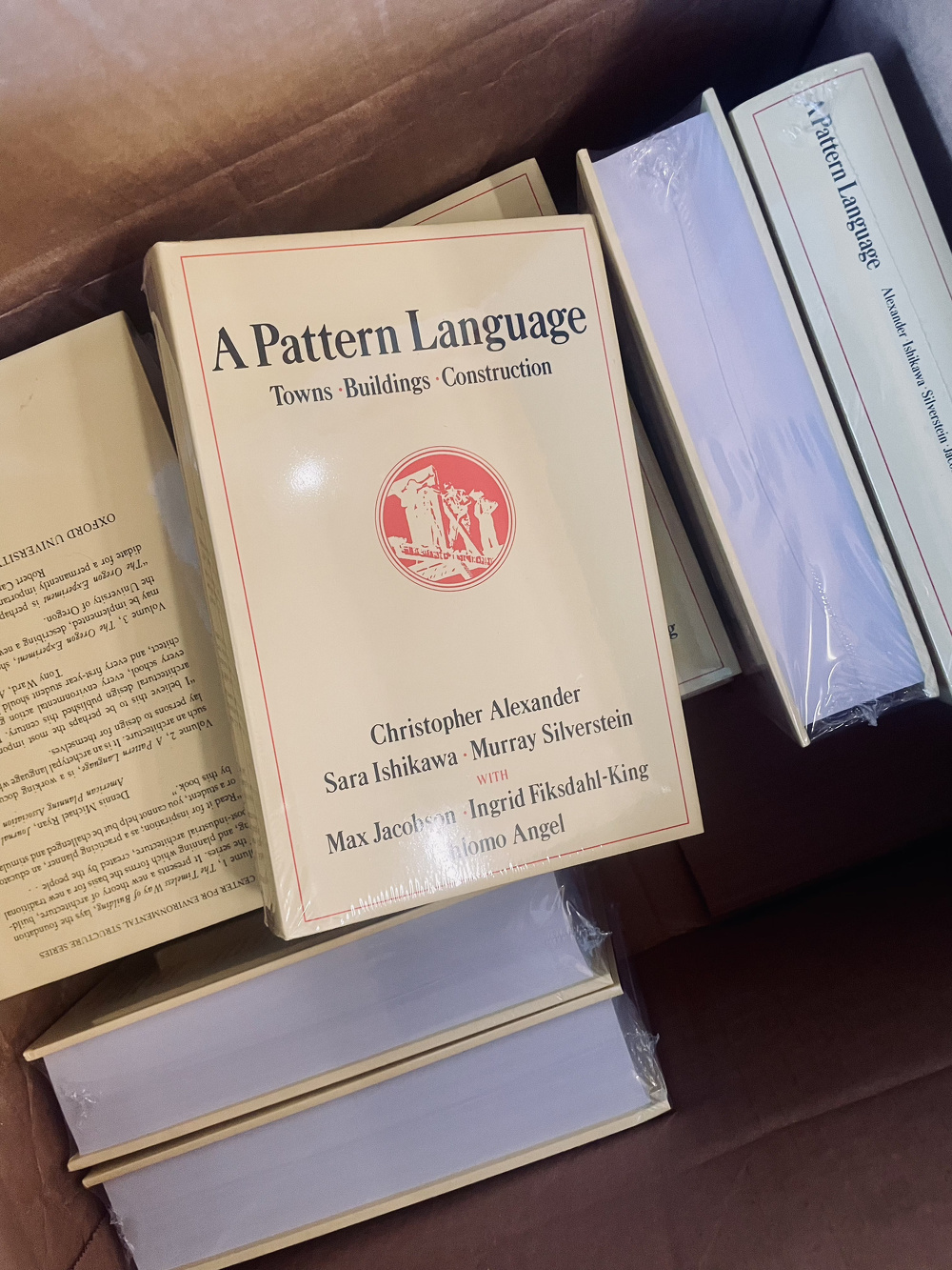 A box full of copies of Christopher Alexander's A Pattern Language.