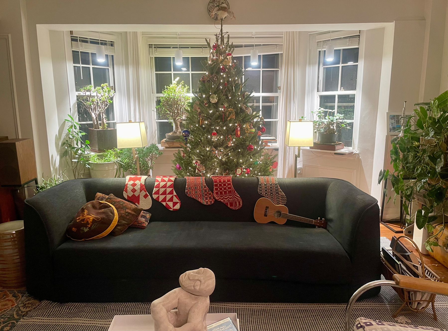 Our living room, with the decorated Christmas tree and bonsais in the bay window 
