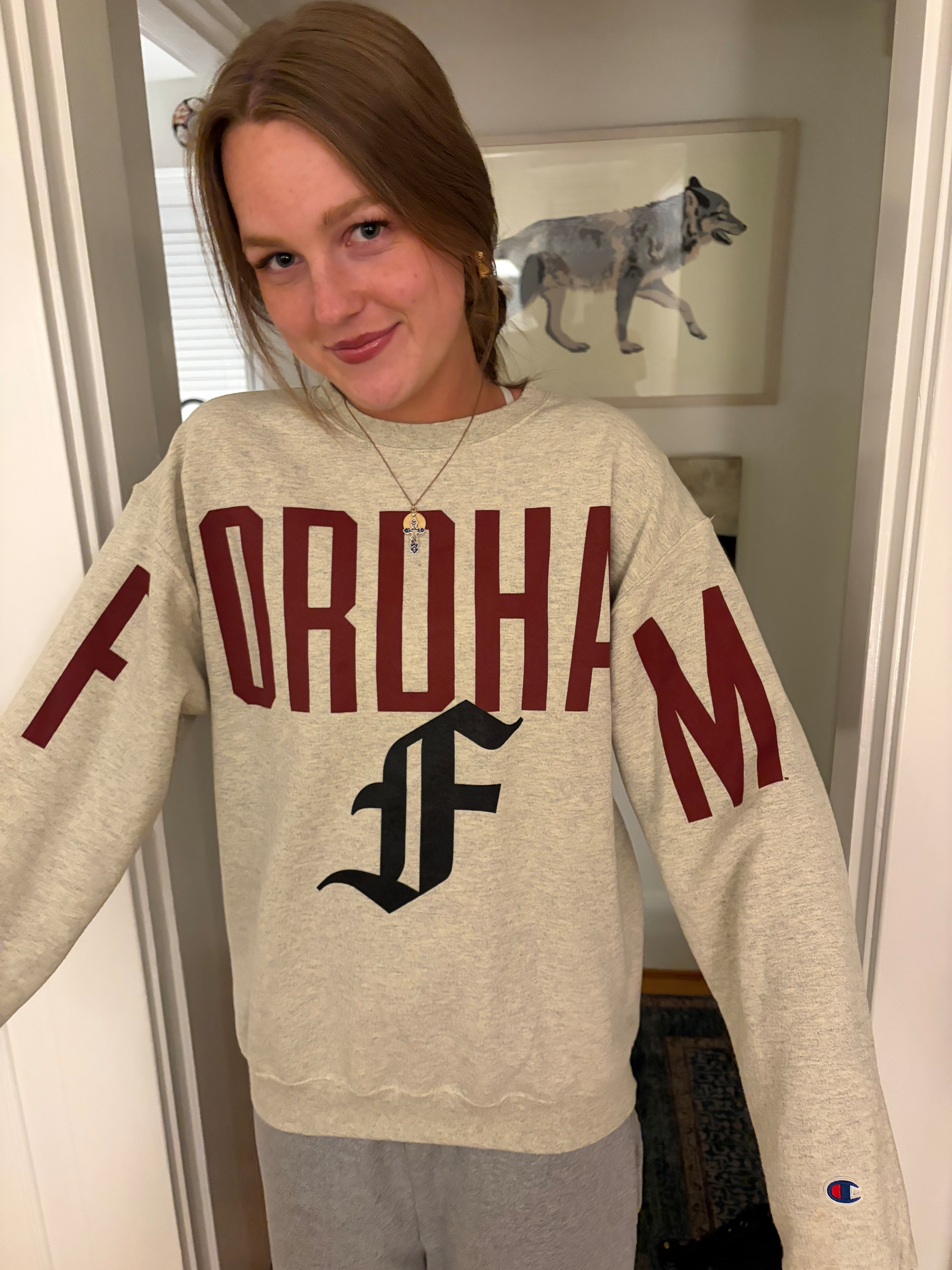 Our daughter wears a Fordham sweatshirt, smiling. 