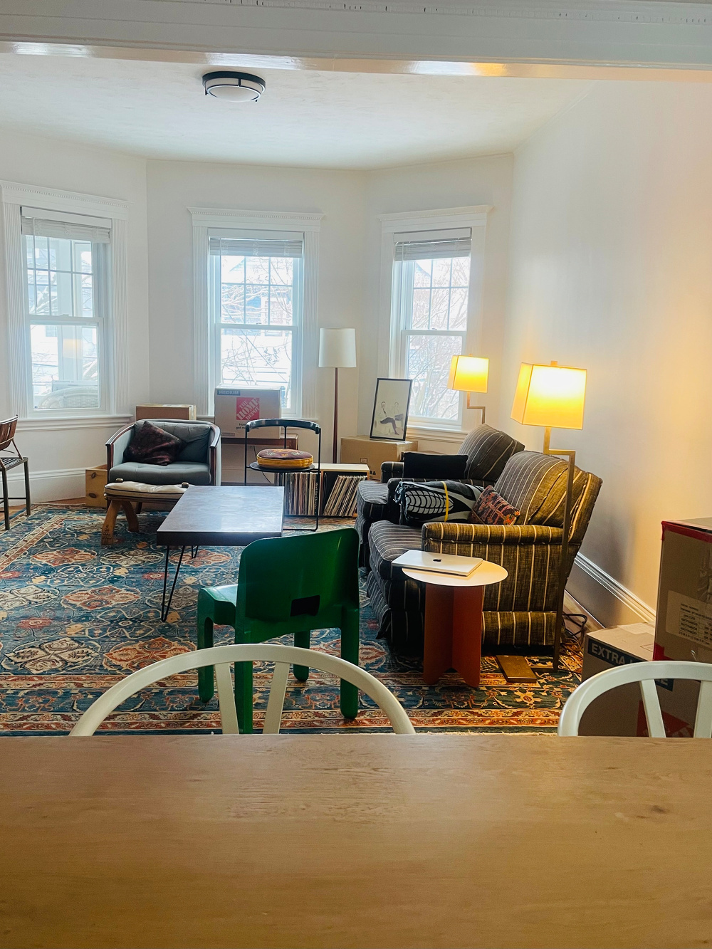 A shot of our living room with furniture, records, artwork strewn about.