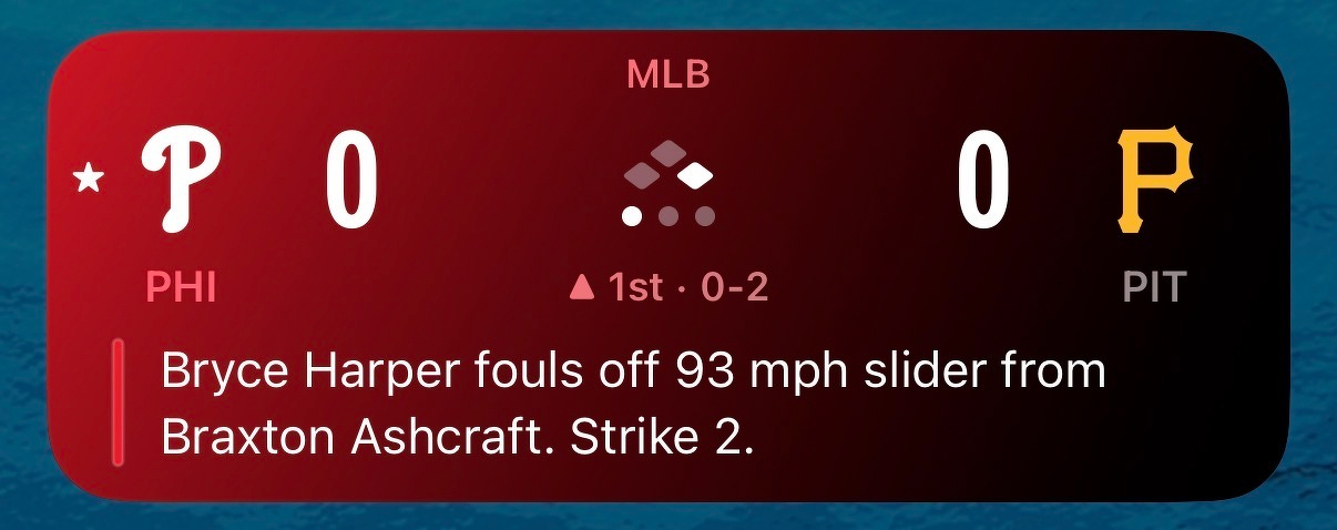 A baseball game scoreboard shows the Philadelphia Phillies and Pittsburgh Pirates tied at 0-0, with Bryce Harper fouling off a 93 mph slider from Braxton Ashcraft.
