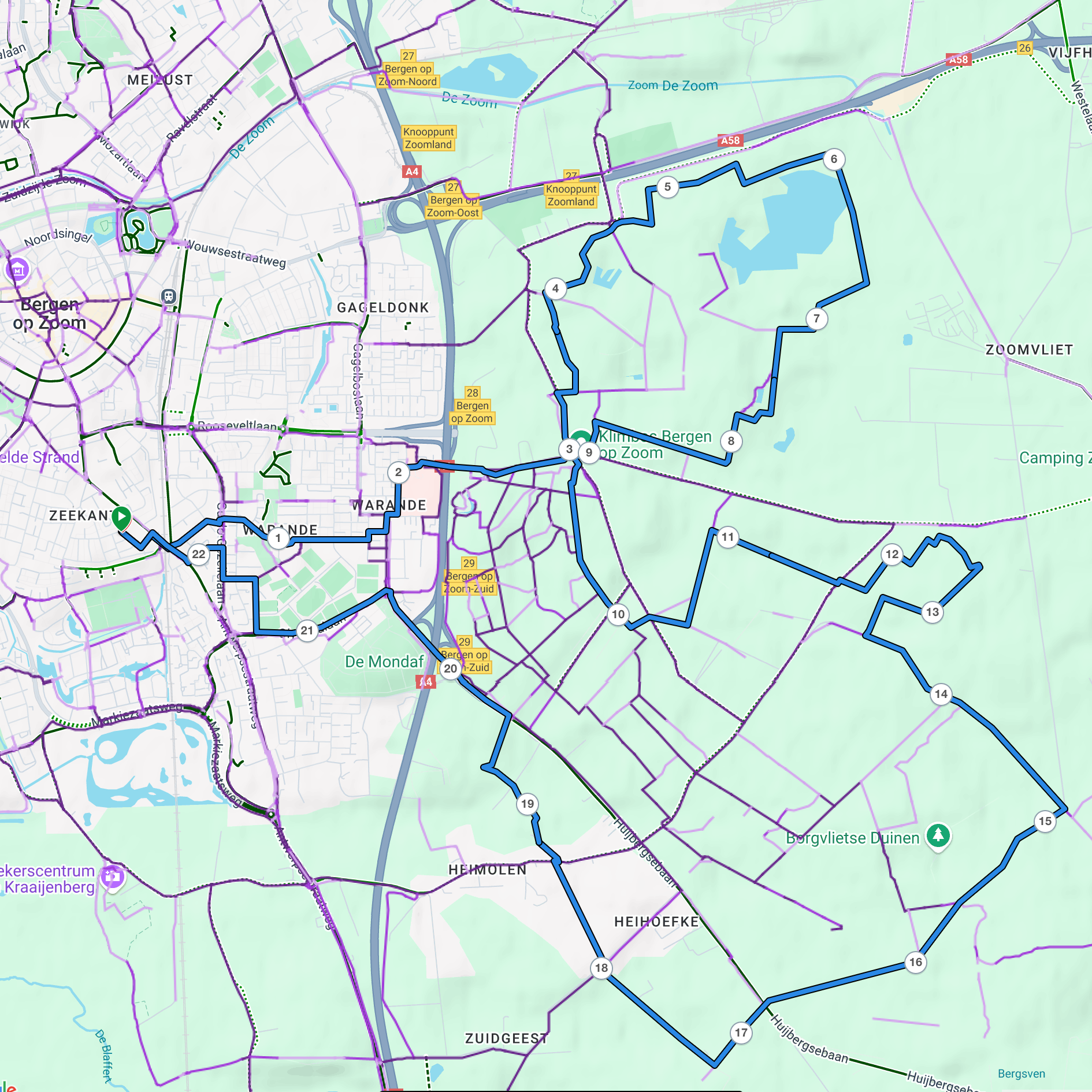 Een gedetailleerde kaart bevat wegen, fietspaden en gemarkeerde routes rond een stad met labels voor verschillende buurten en bezienswaardigheden.