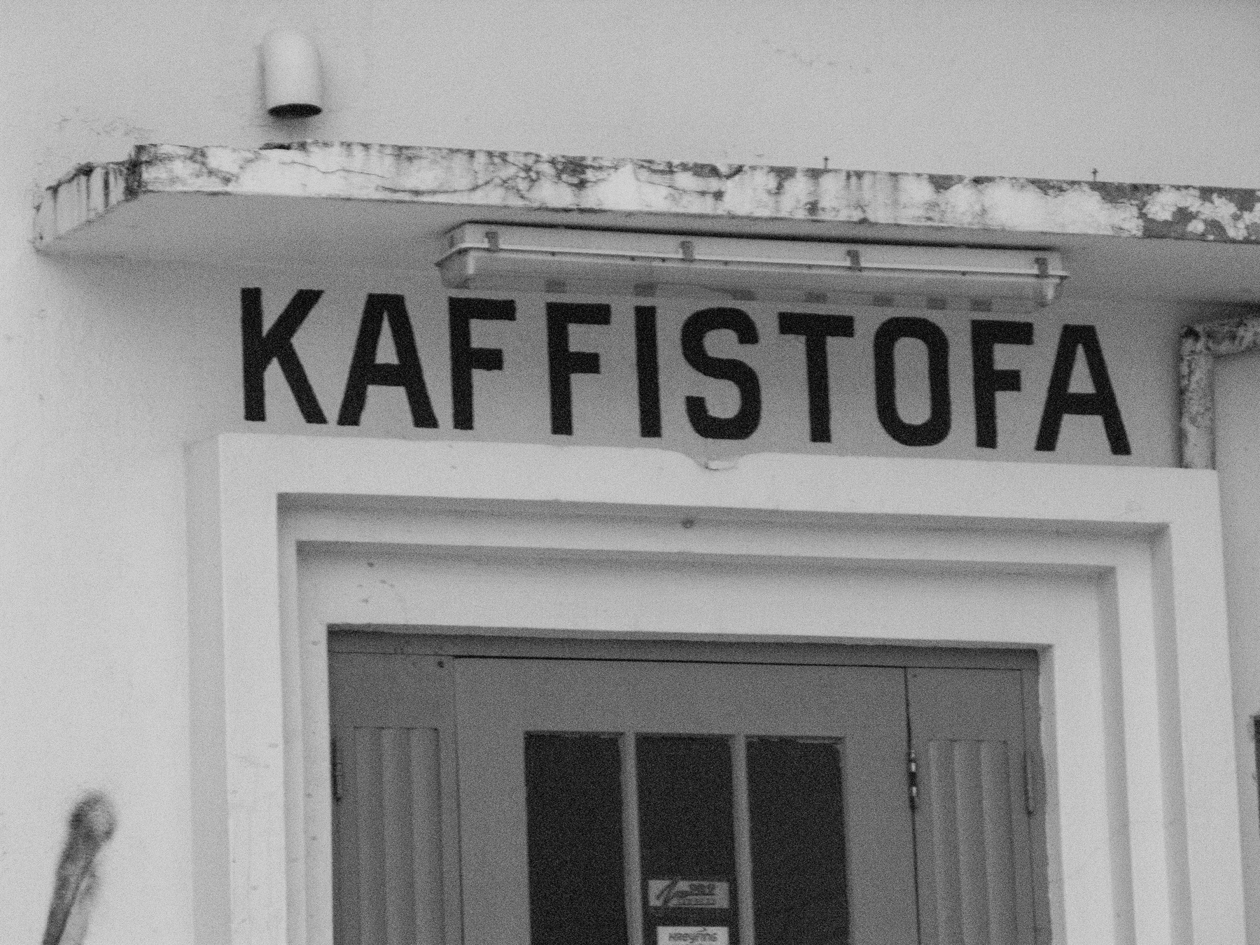 An entrance to a “kaffistofa” as the sign above the door says. This is the opposite of a café. A place where coffee is a utilitarian beverage.