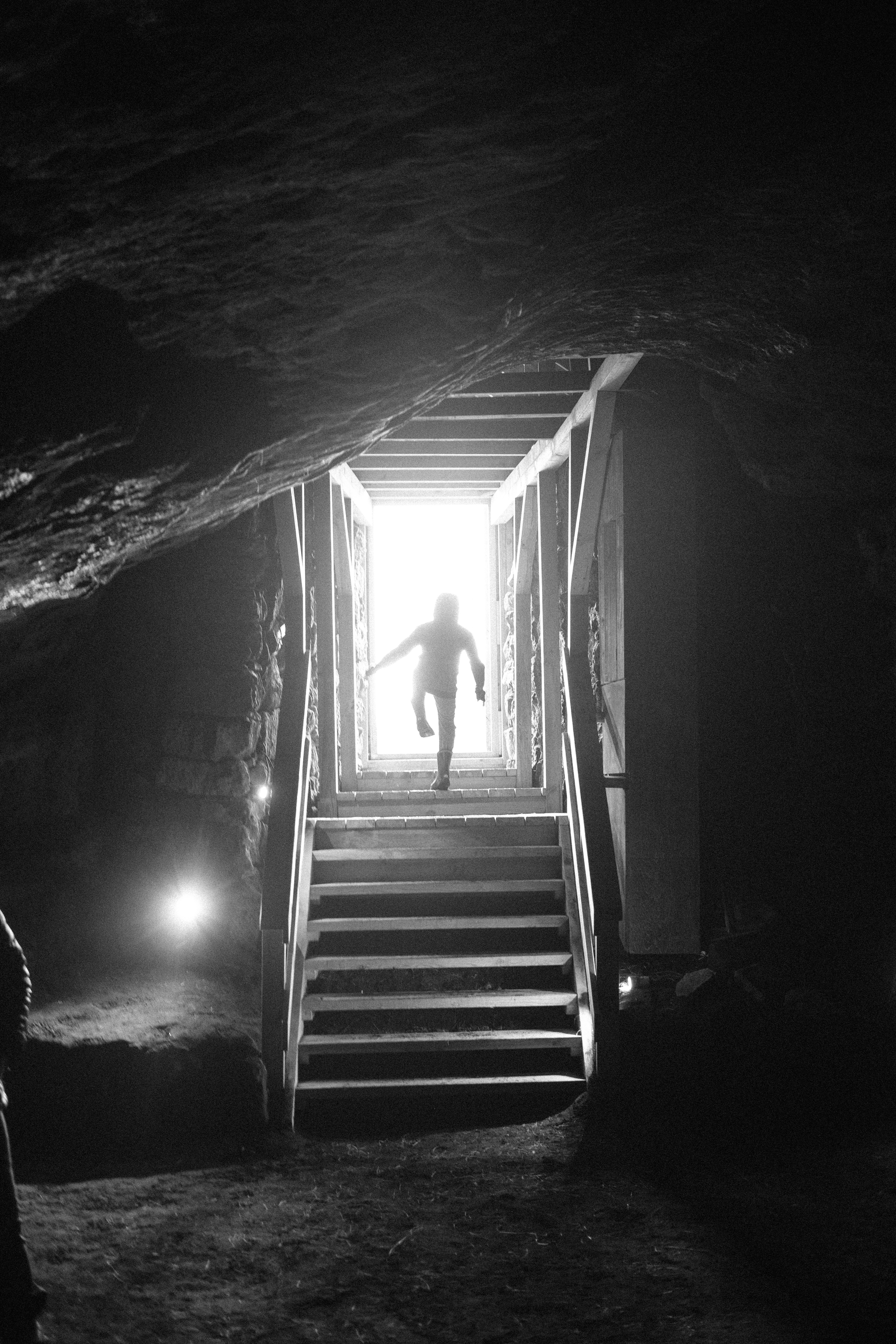 The silhouette of a kid exiting the cave
