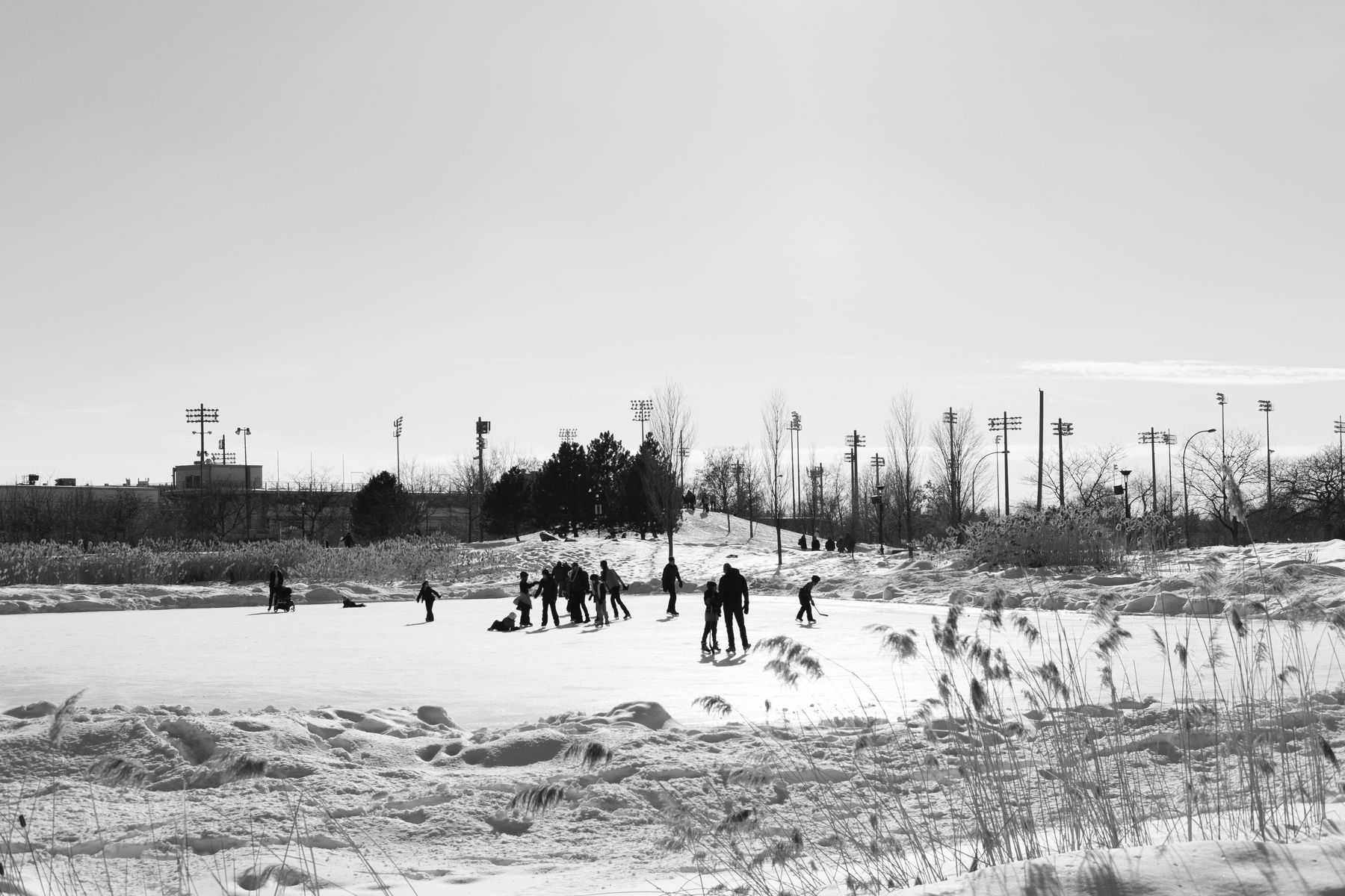 People skate on a frozen pond.
