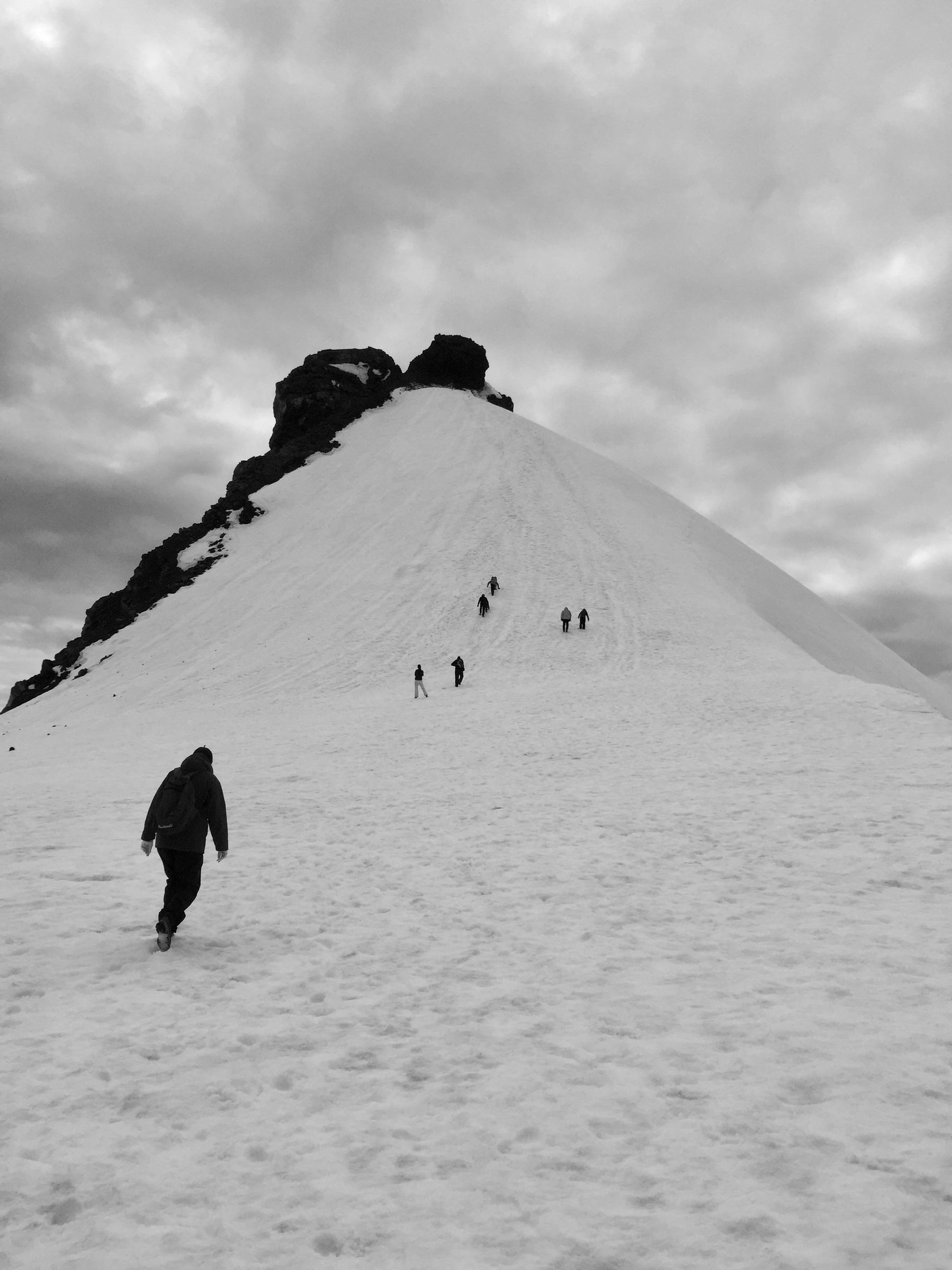 A group of people walk up the peak of Snæfellsjökull.