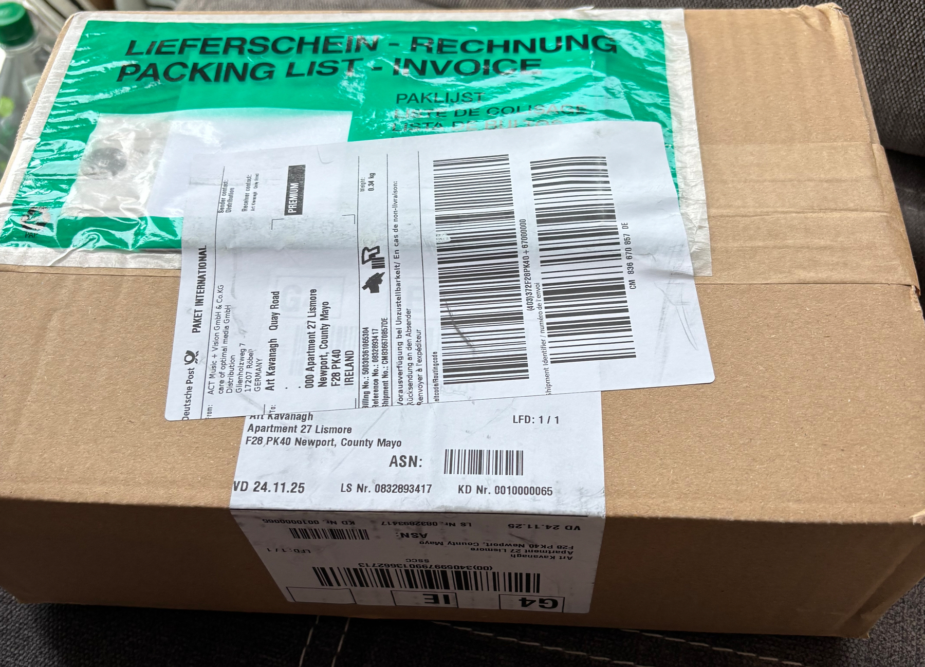 Cardboard box large enough to fit four hardback books, with postage labels.