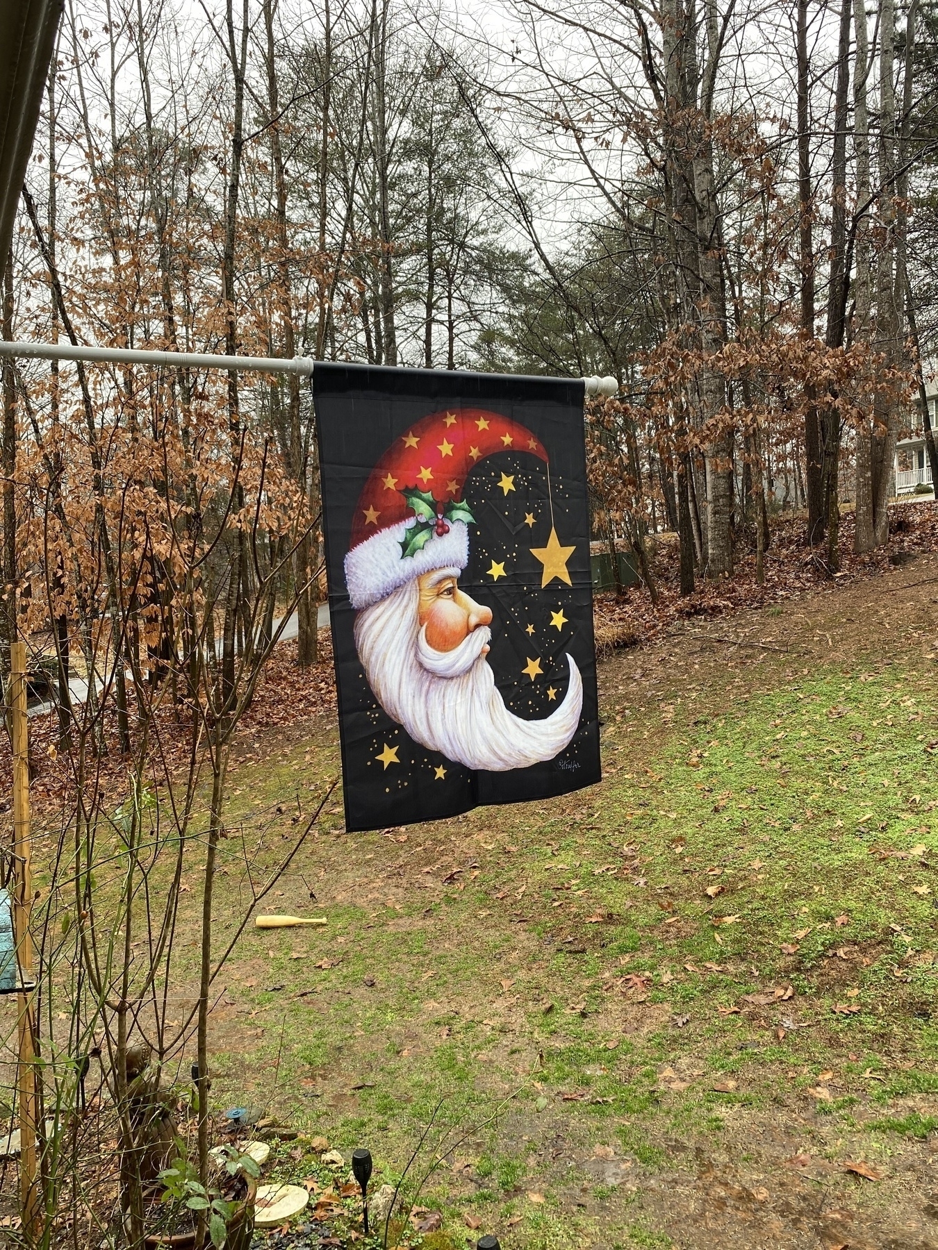 A picture of a flag with a Santa Claus shaped like a crescent moon.