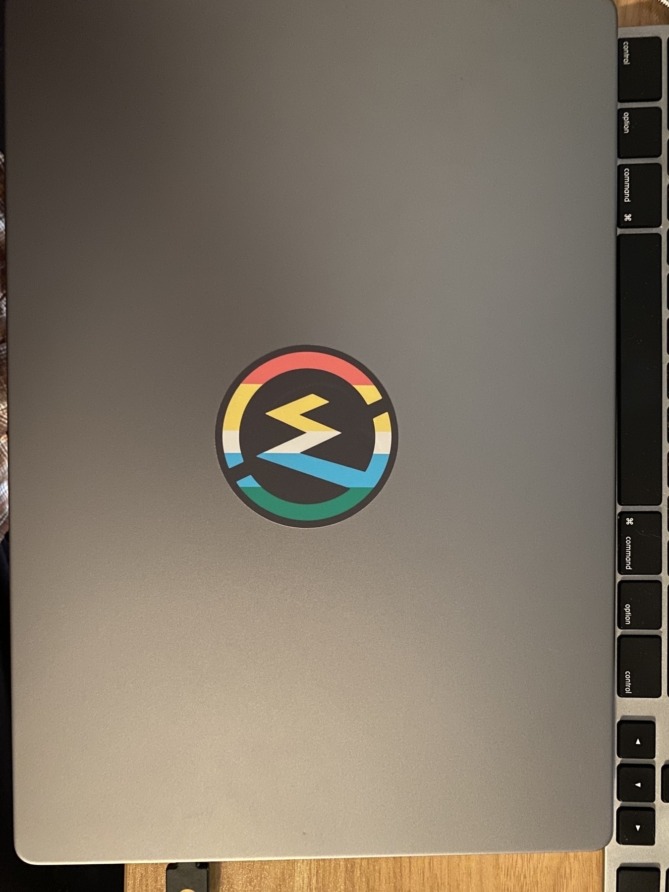 A picture of a MacBook Pro with a WillowTree sticker covering the Apple logo.