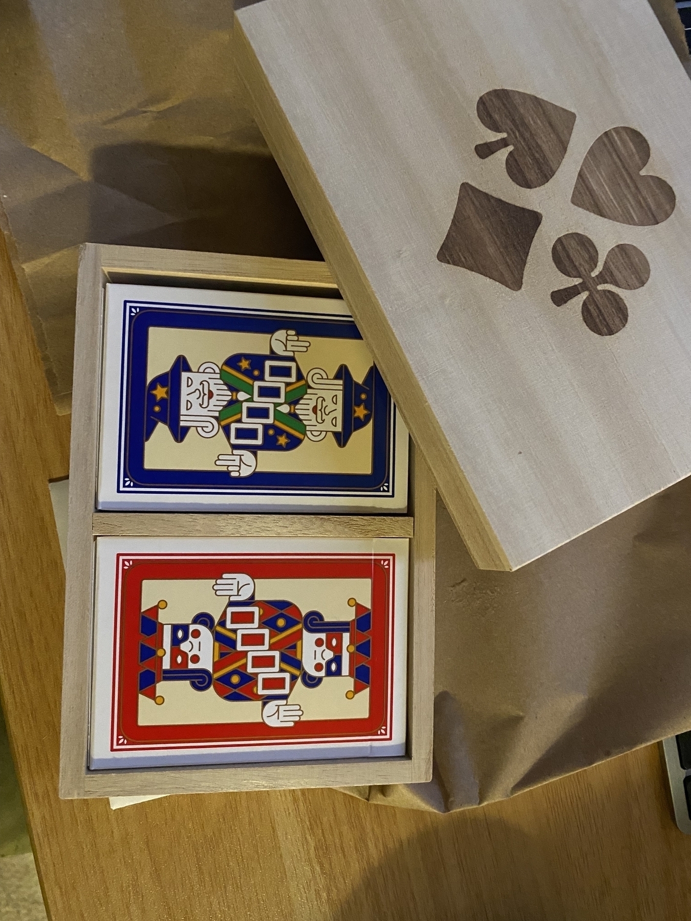 A picture of two playing card decks in their wooden box.
