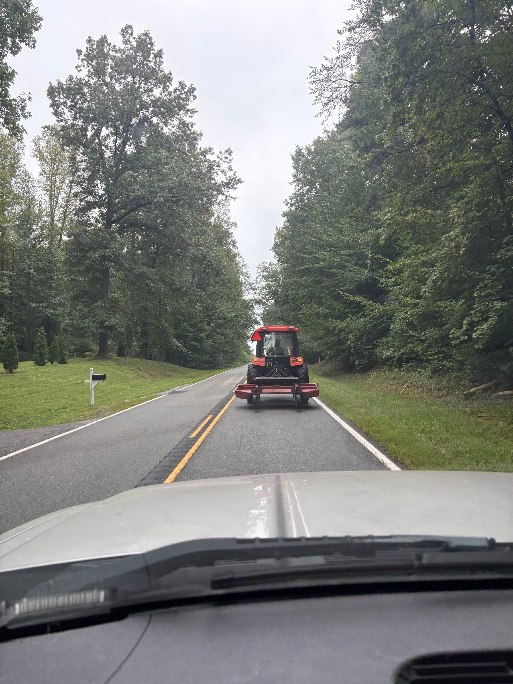 Picture of a tractor driving down the road.