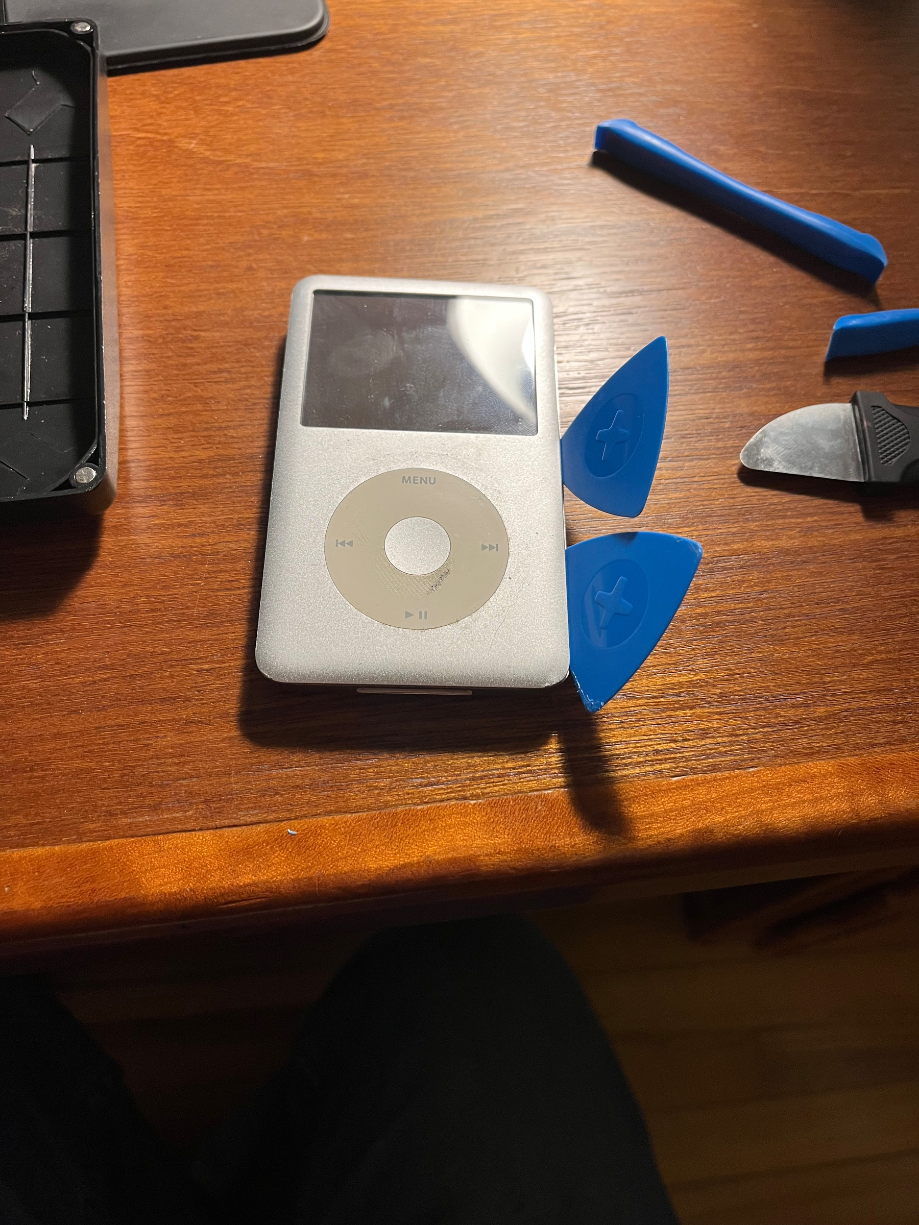 An iPod with plastic wedges sticking out of it