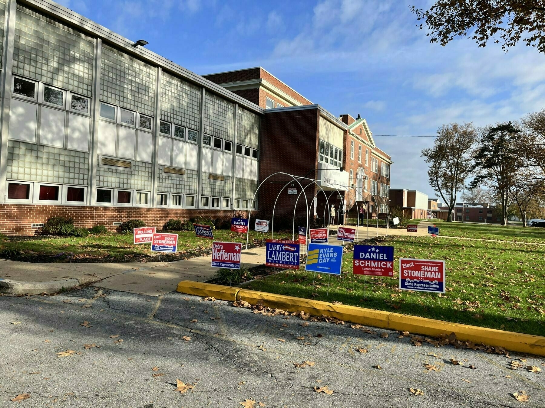 The exterior of the Claymont Community Center this morning. Weather is beautiful and sunny. Many signs for candidates out front.