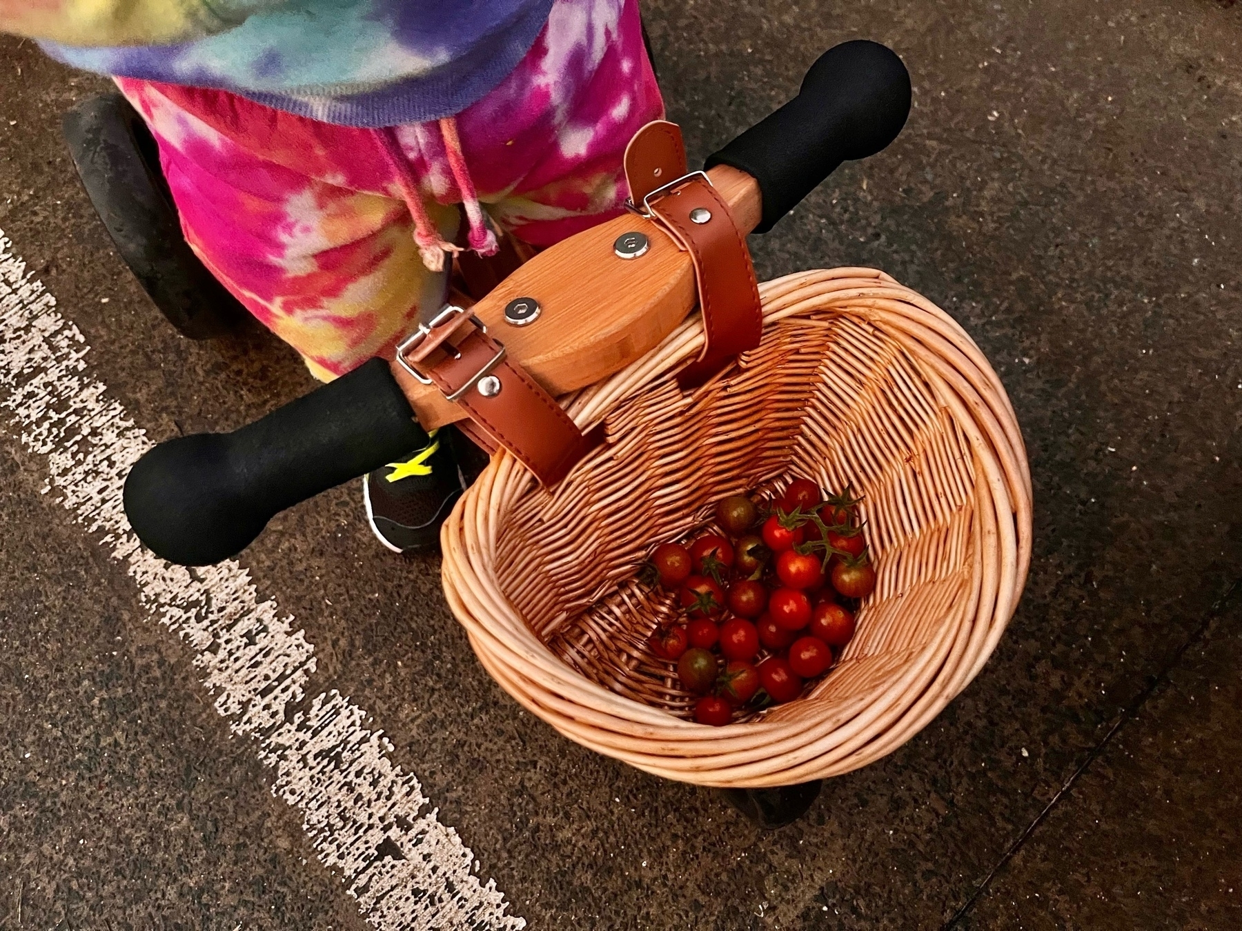 Cherry tomatoes in the basket of a kid's trike