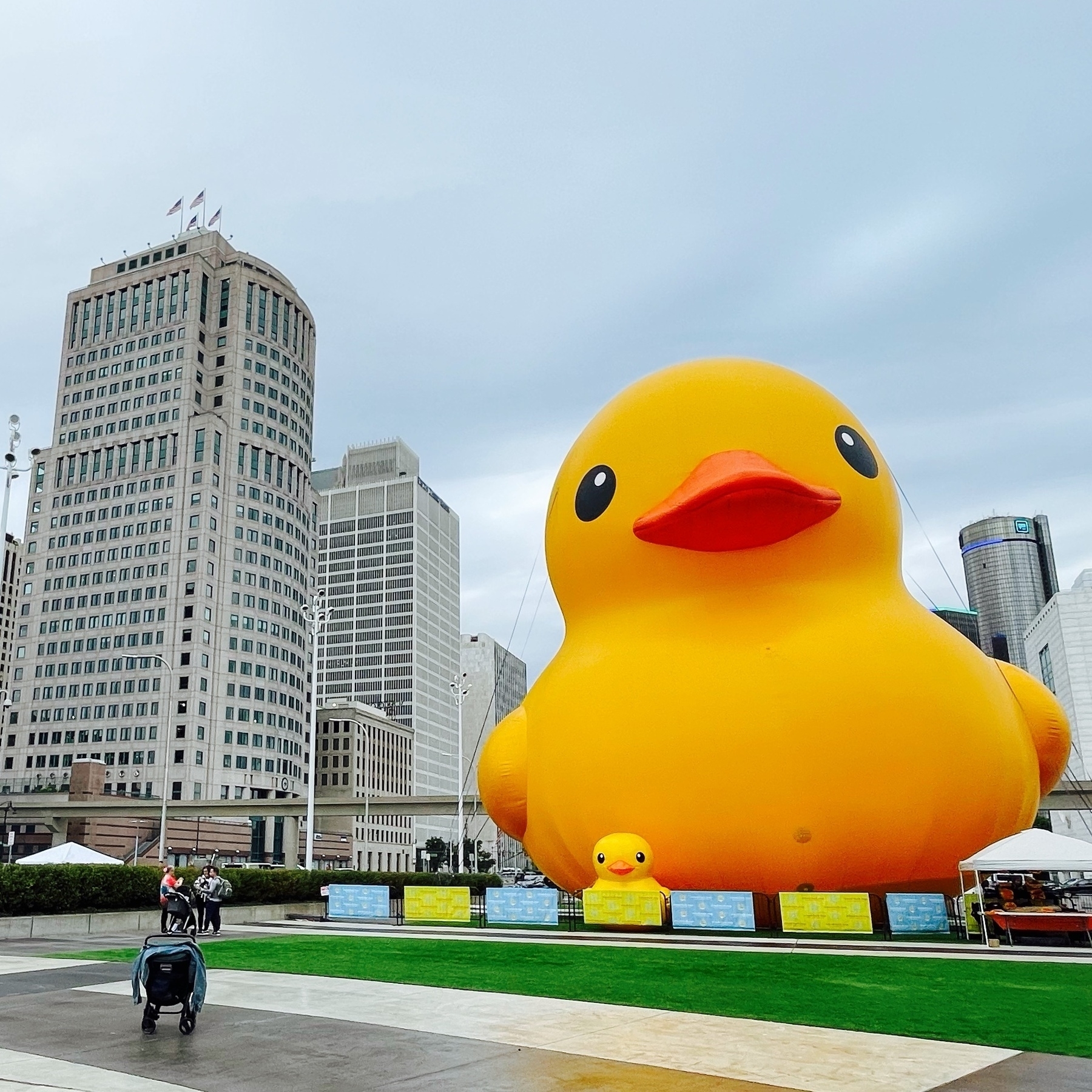 large inflated rubber duck in front of Detroit skyline