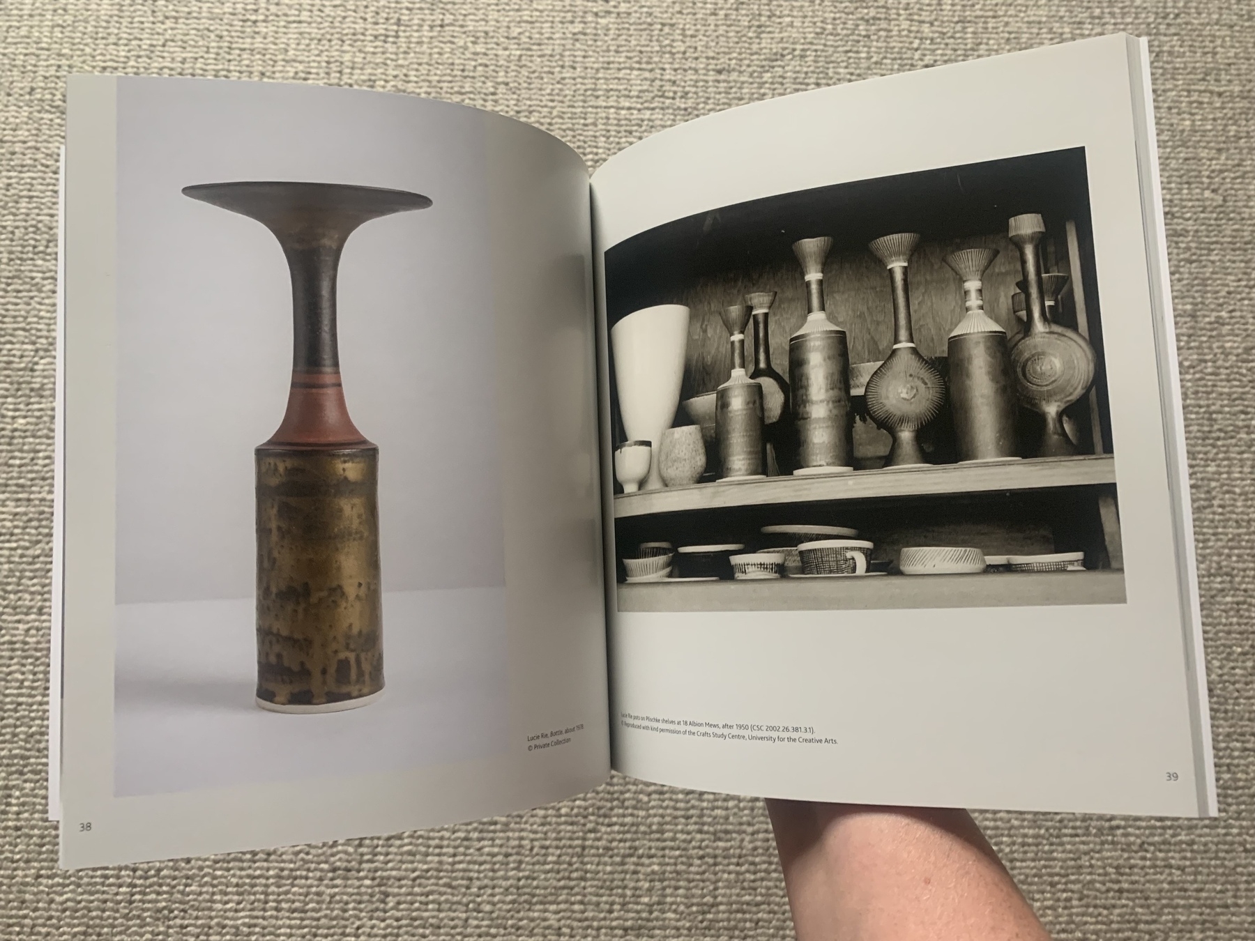 Double spread of an open book featuring two photographs of ceramic vases made by Lucy Rie.