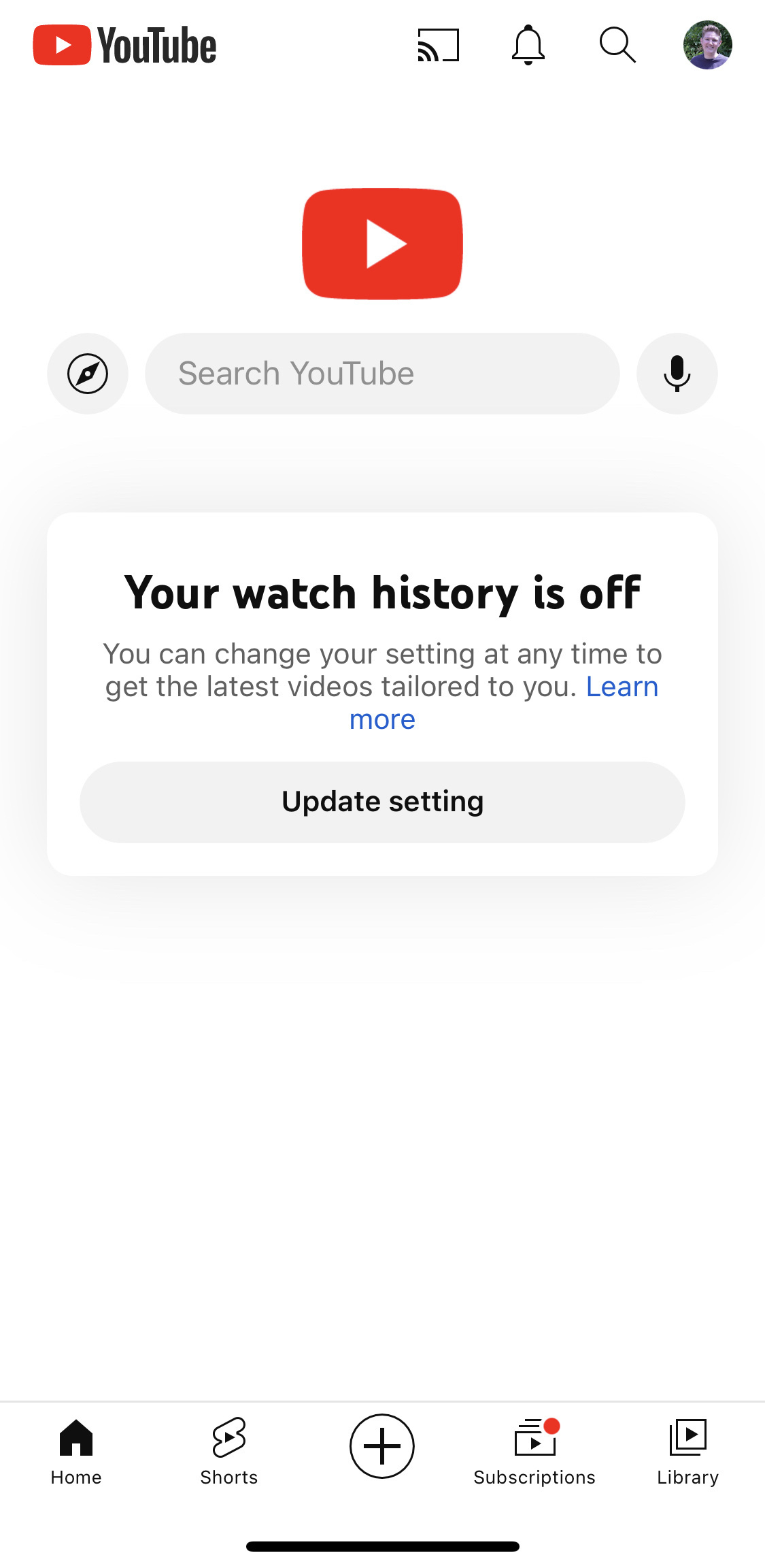 Screenshot of YouTube app with a completely white screen. An alert box reads “Your watch history is off. You can change your setting at any time to get the latest videos tailored to you.” The call to action is a button to update settings.