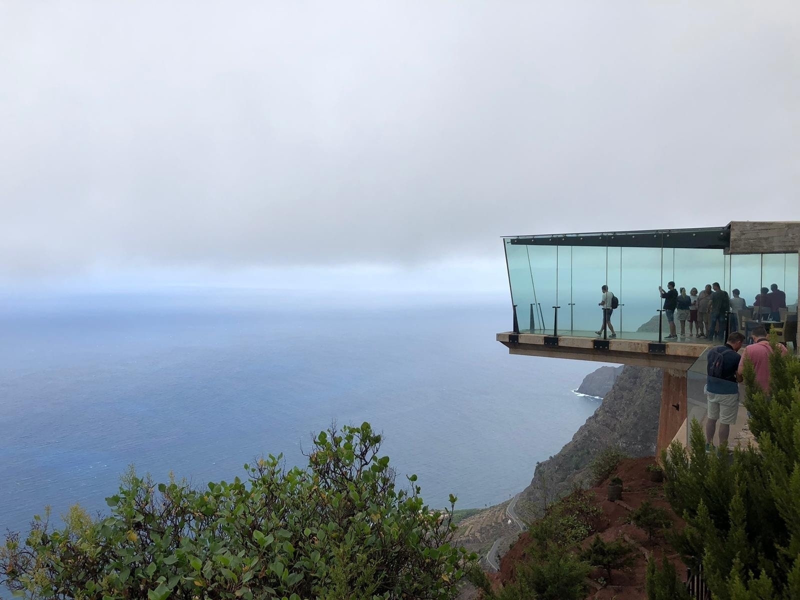 Glass viewing platform hanging over the edge of a cliff.