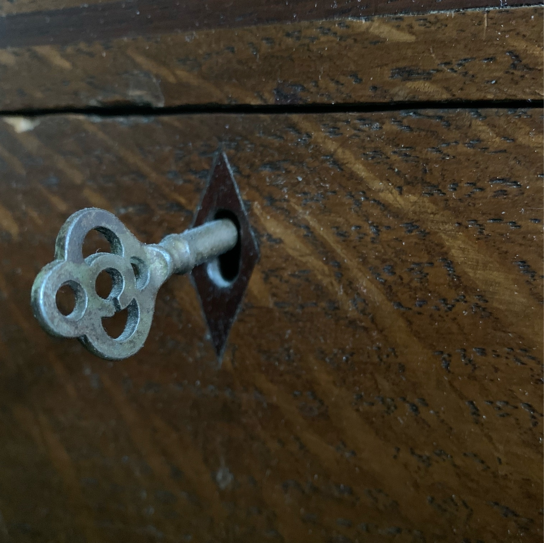 Decorative key in the lock of a wooden box