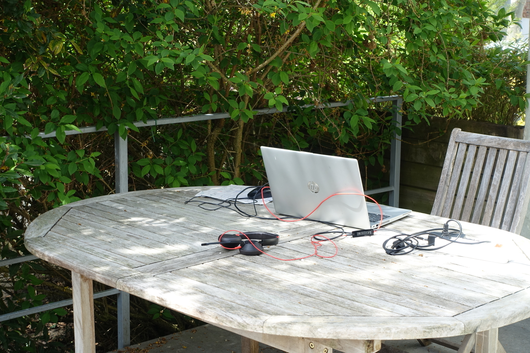laptop on a sunny terrace in the green