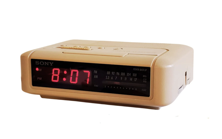 Cream colored small clock/radio with red LED display