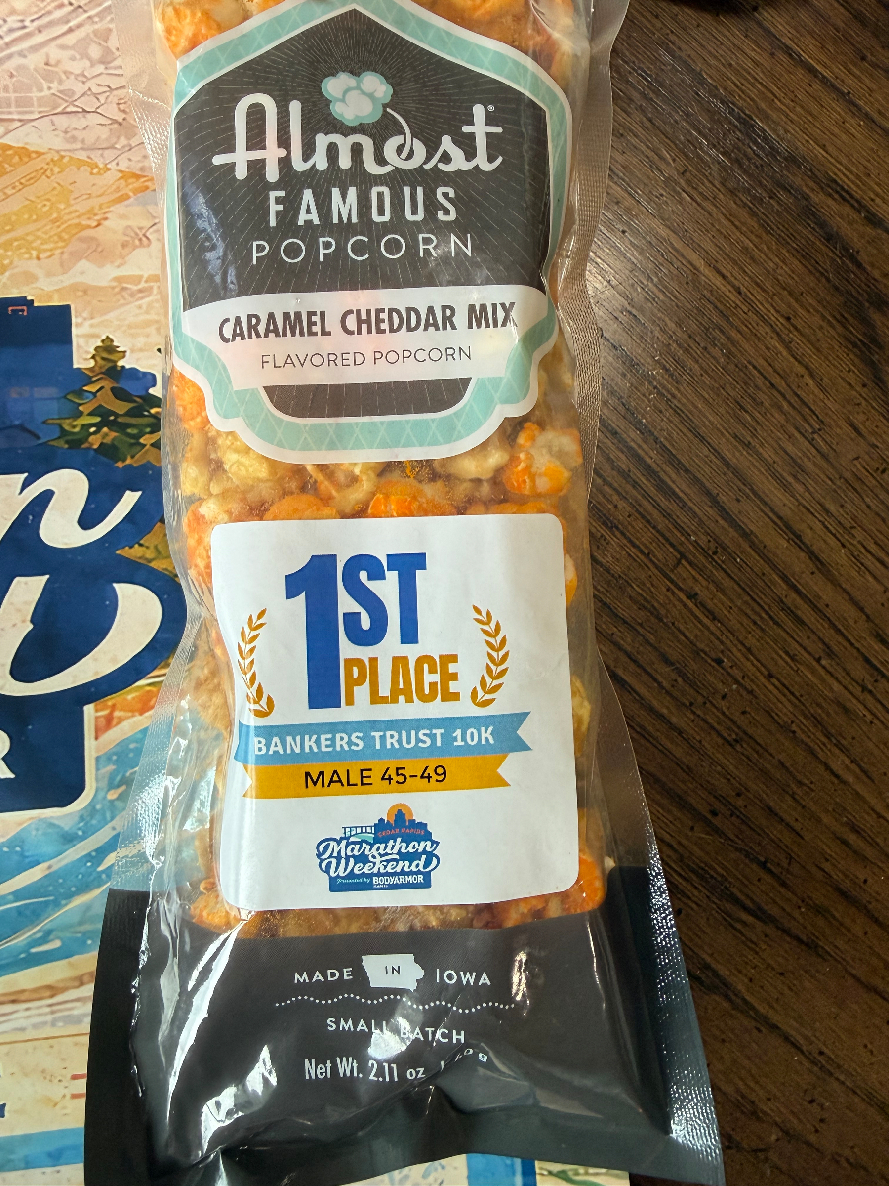 A package of Almost Famous Popcorn caramel cheddar mix is awarded for 1st place in a Bankers Trust 10K for males aged 45-49.