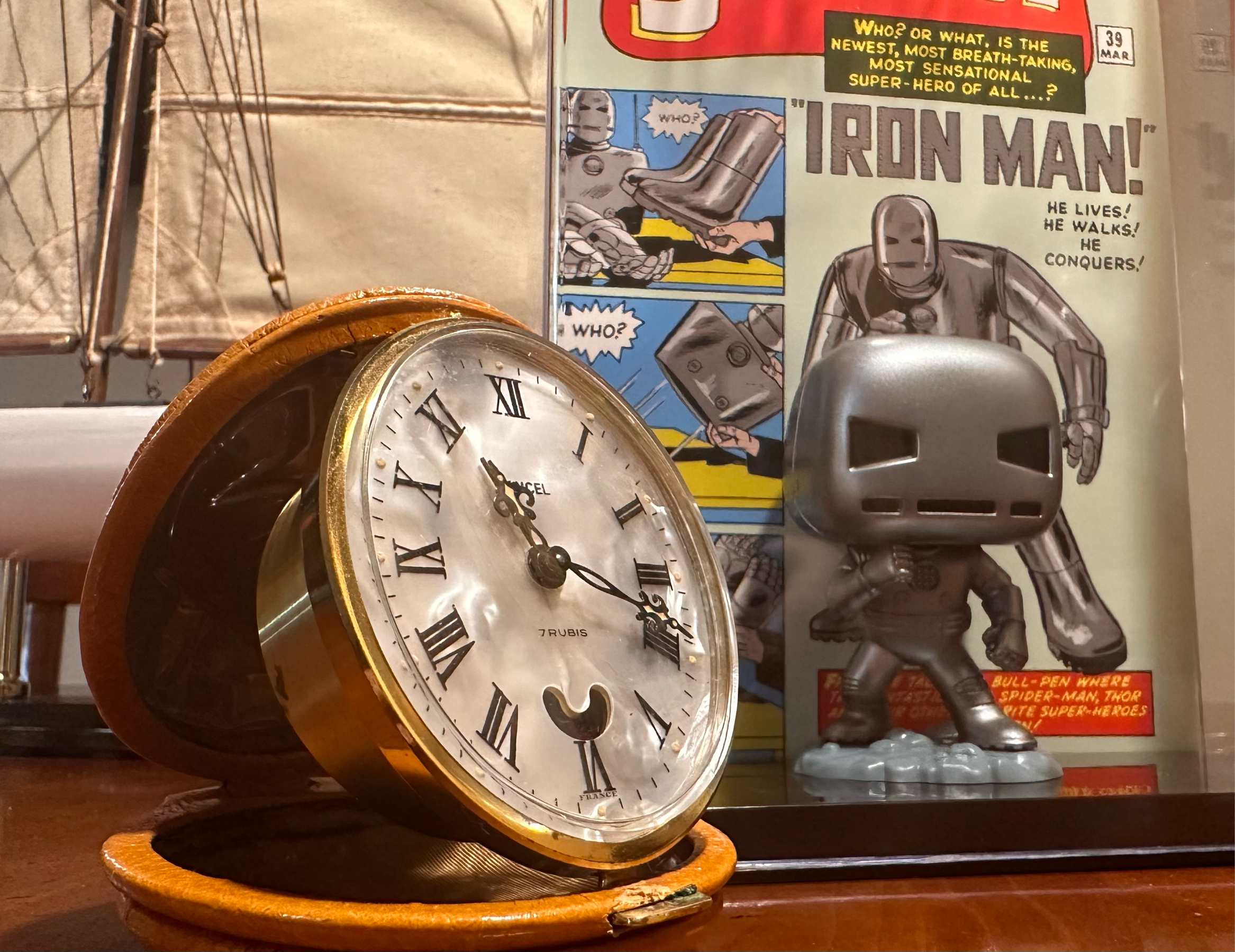 Vintage travel alarm clock and Iron Man funko. 