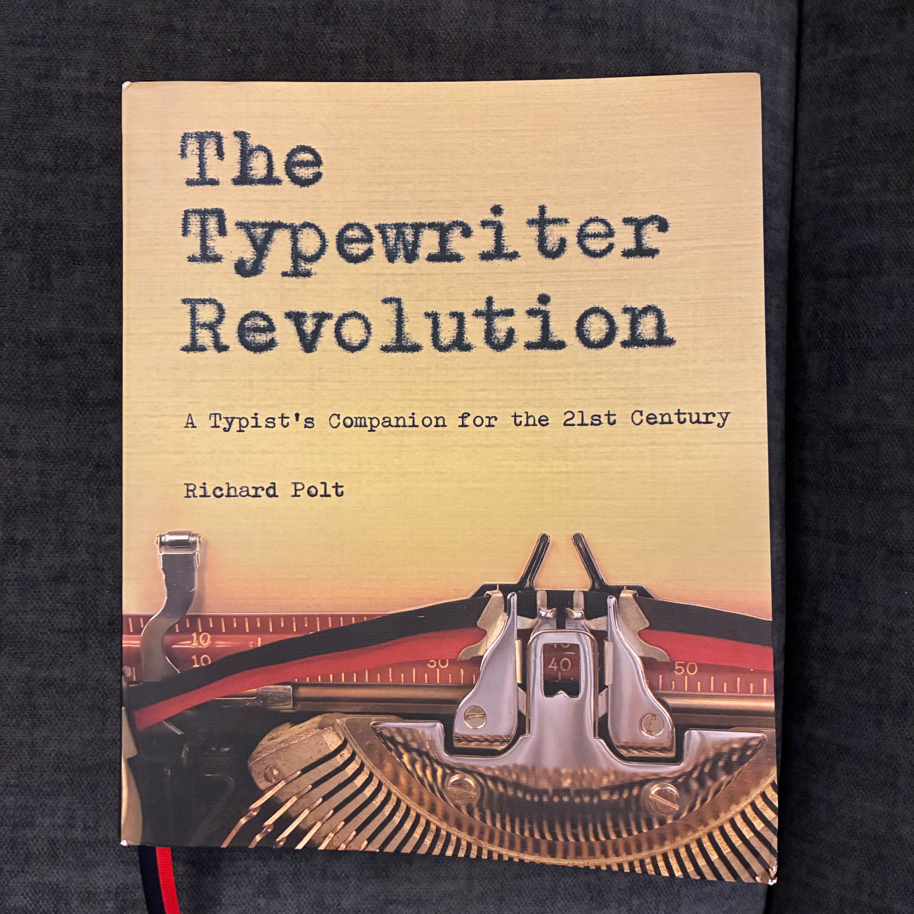 A book titled The Typewriter Revolution: A Typist's Companion for the 21st Century by Richard Polt features an image of a typewriter on its cover.