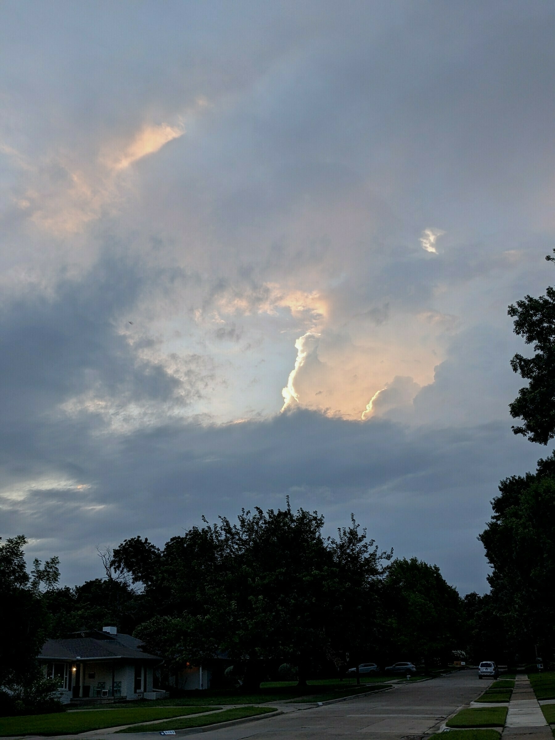 sunrise and clouds on a dark suburban street