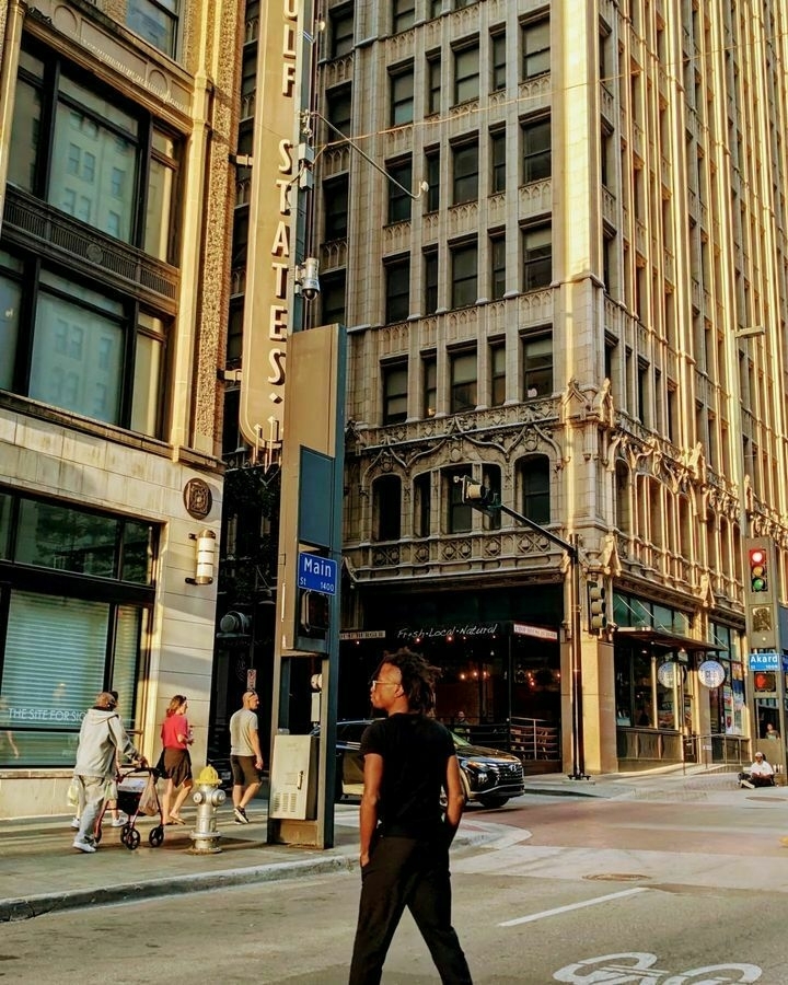 Downtown Dallas crosswalk with tall buildings behind.