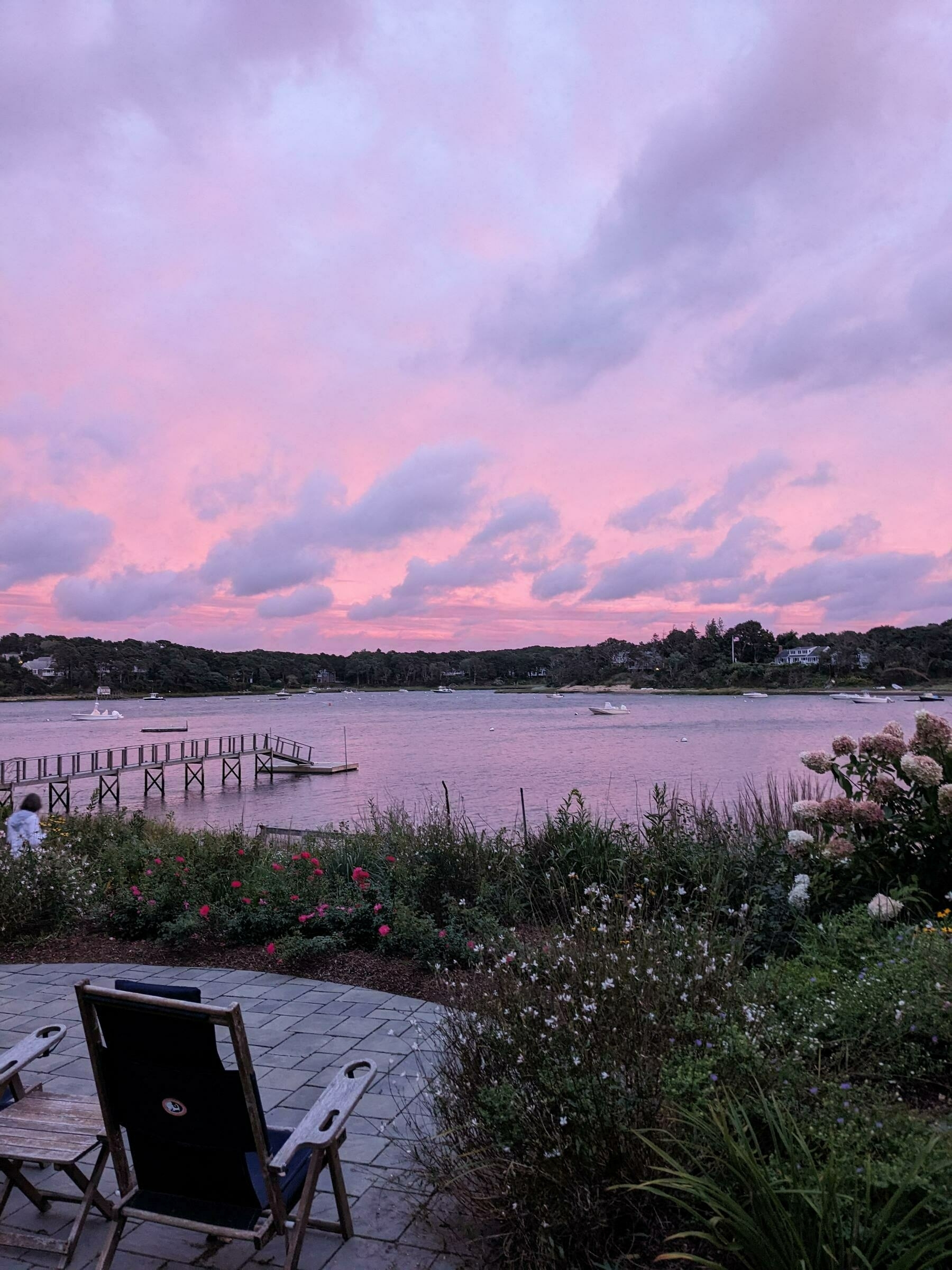 Orangey and blue clouds over a Cape Code inlet at sunset.