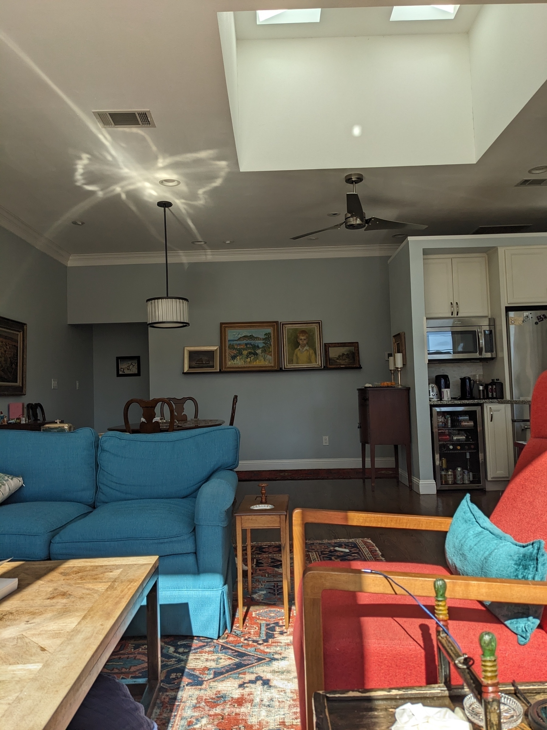 a sunny interior of a house with bright blue and orange fabric on furniture