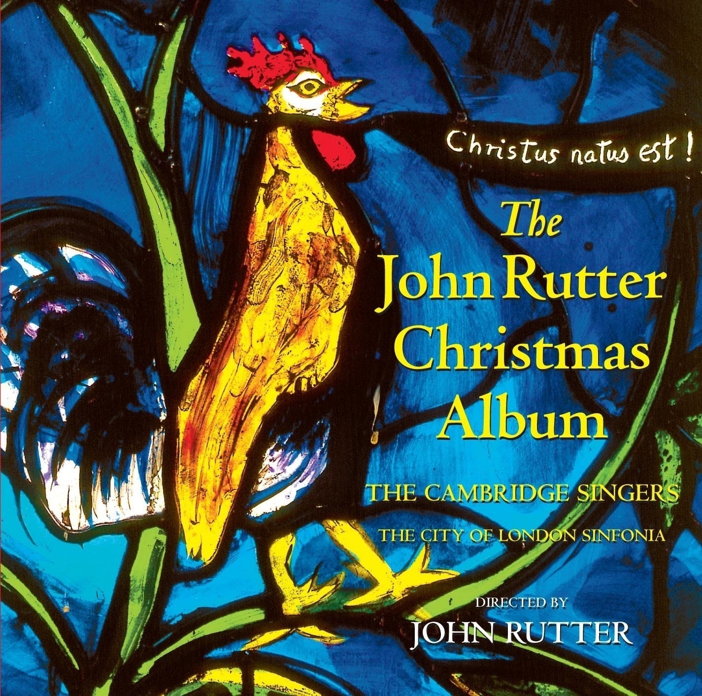 Auto-generated description: A colorful, artistic depiction of a rooster is featured on the cover of The John Rutter Christmas Album, alongside text highlighting the Cambridge Singers and the City of London Sinfonia.