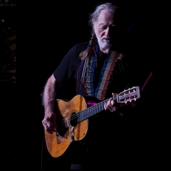 Willie Nelson playing his guitar, Trigger