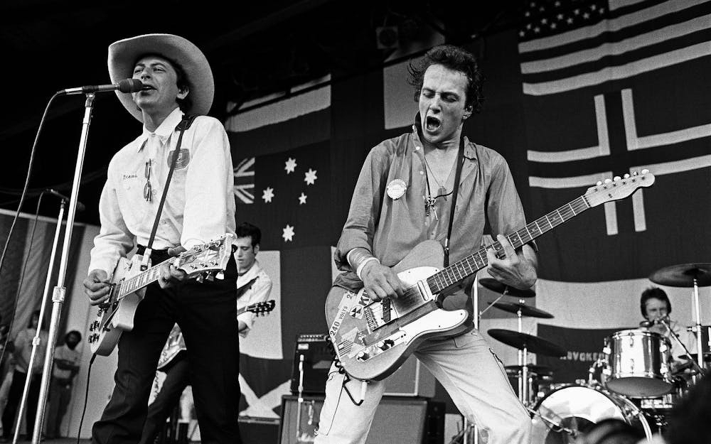 Joe Ely performs with Joe Strummer in 1979. Photo credit: George Rose/Getty