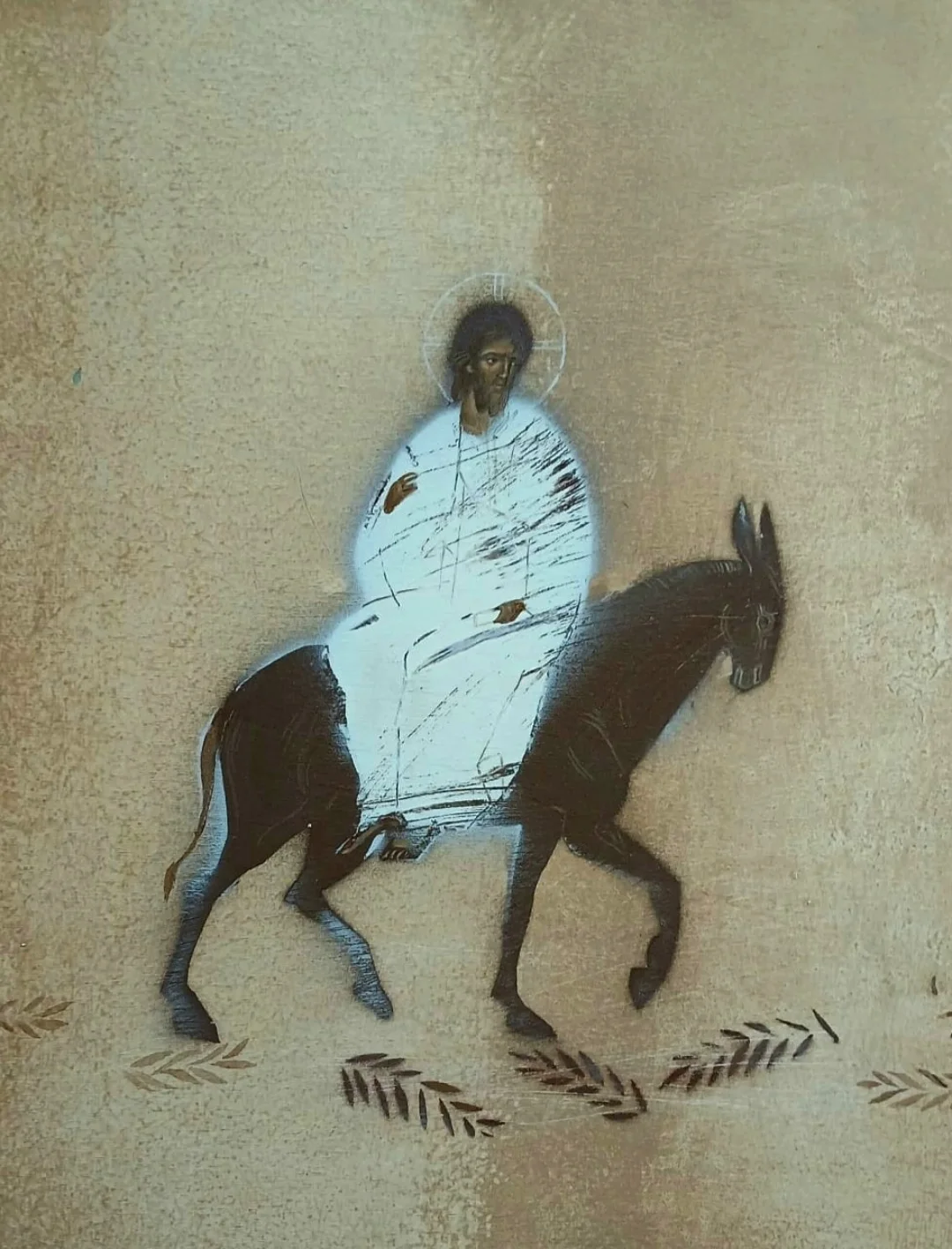 An icon-like painting of Jesus riding a donkey across a surface scattered with palm fronds.