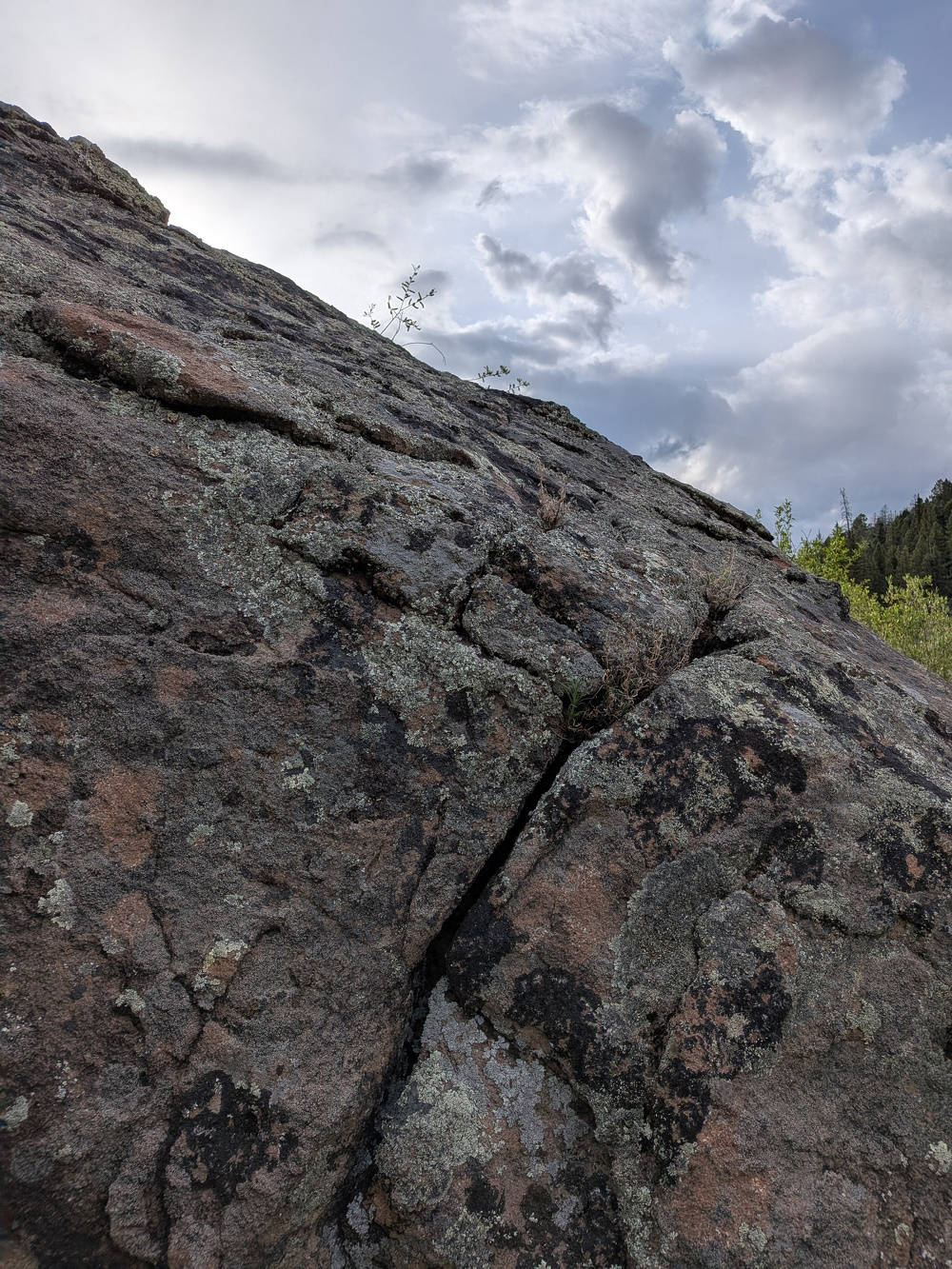A rocky landscape with a cloudy sky in the background.