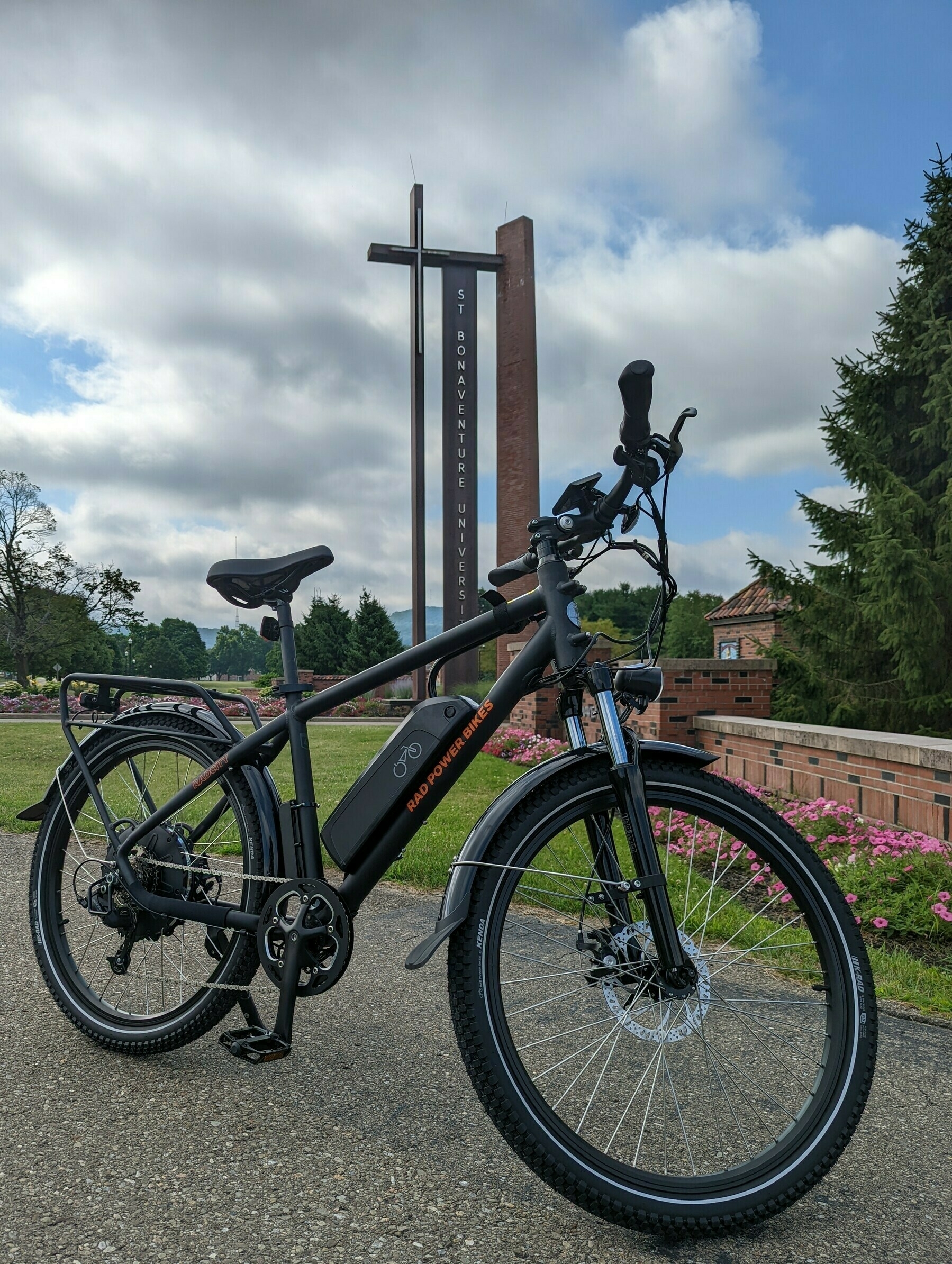 Electric bike in front of the main entrance of St. Bonaventure University