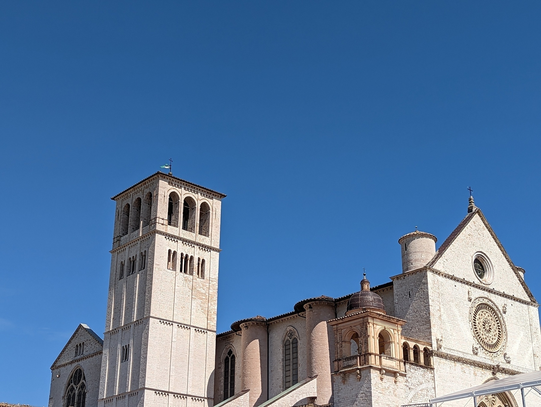 White limestone church & bell tower agains deep blue sky