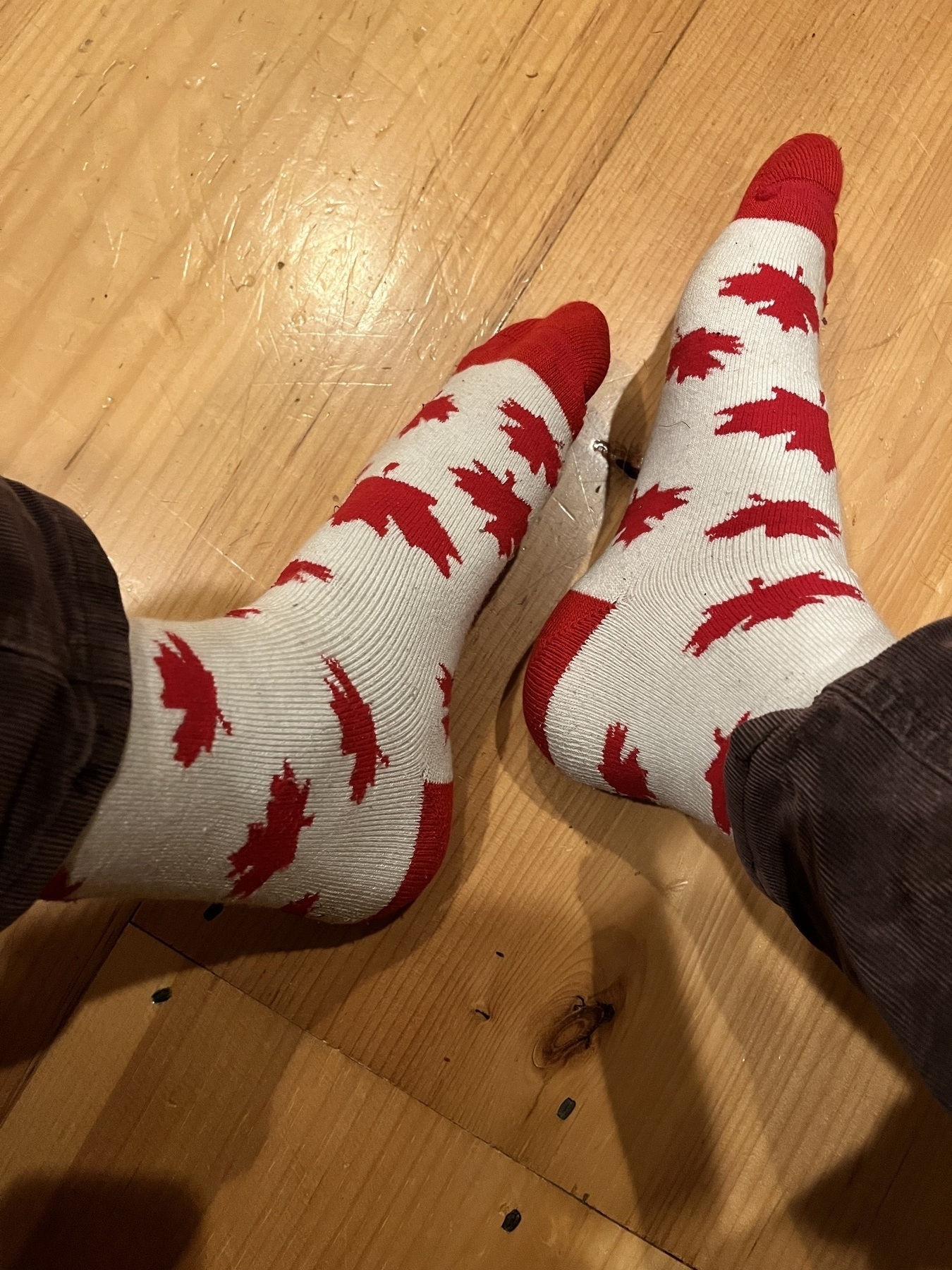 White socks with red maple leaves in the design. 