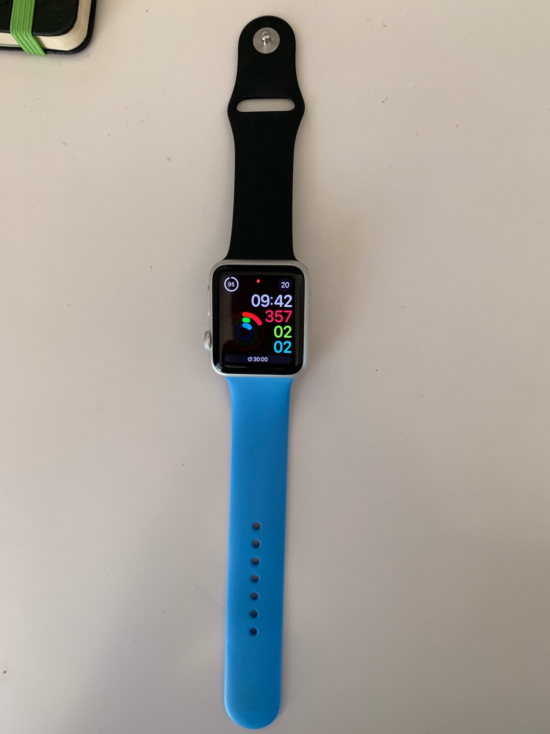 My series 0 apple watch with one blue and one black strap. 