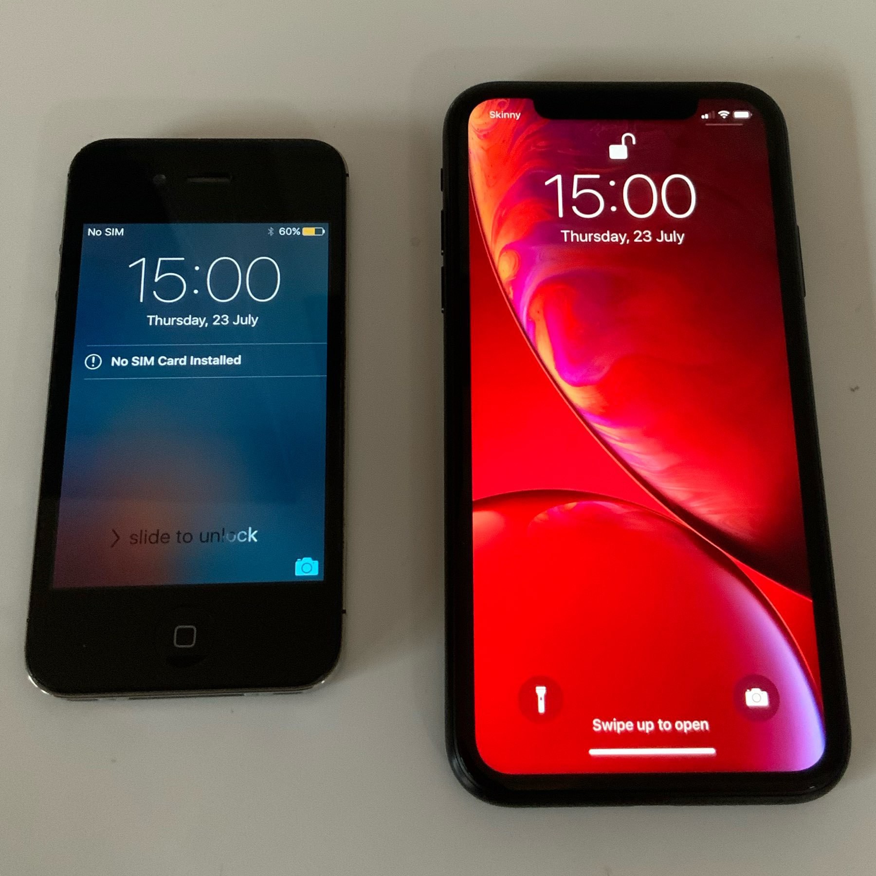 my fixed iphone XR next to my old iphone 4, which has been my carry phone for a few days